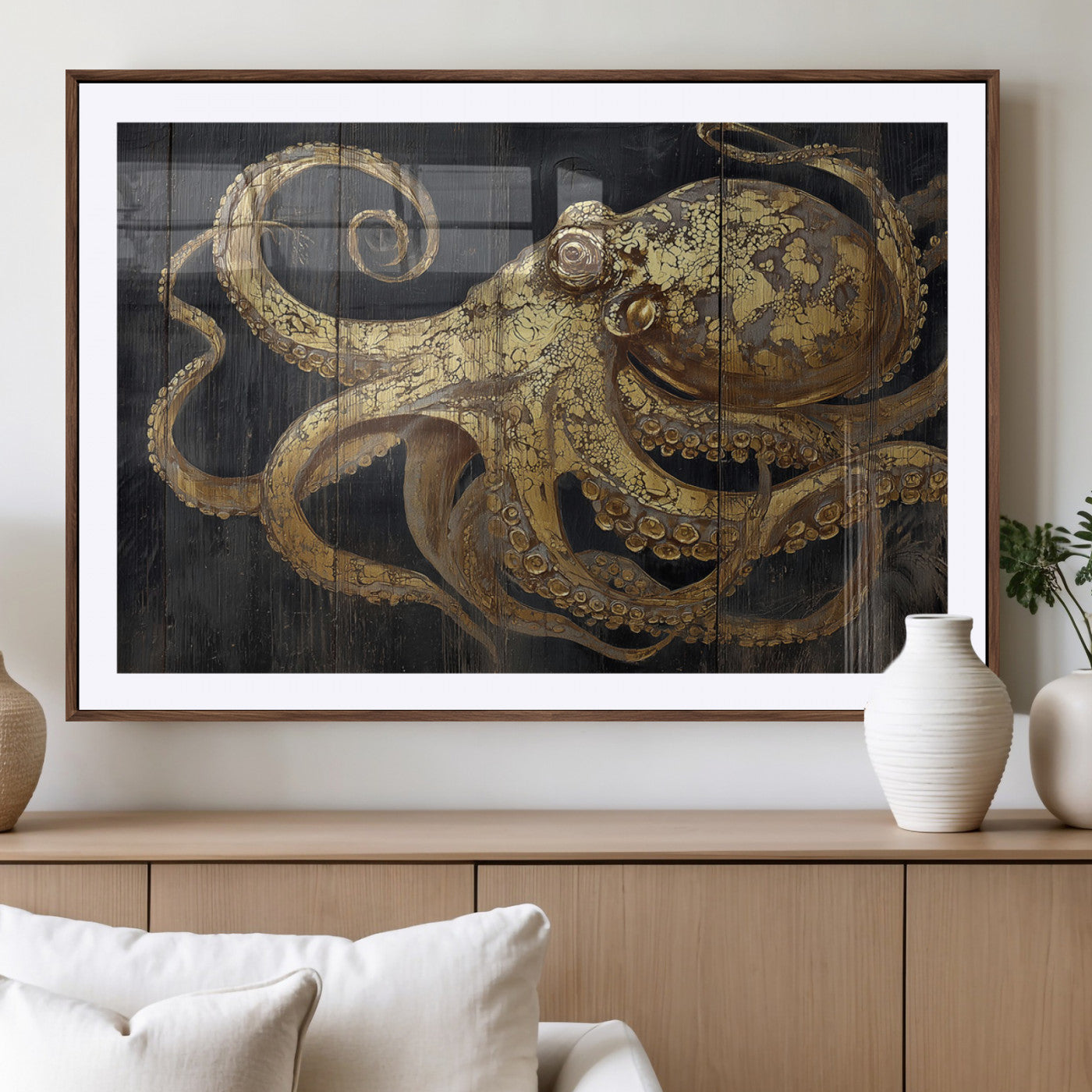 A detailed gold illustration of an octopus on black wooden planks, showing its intricate tentacles and textured skin in an artistic style.
