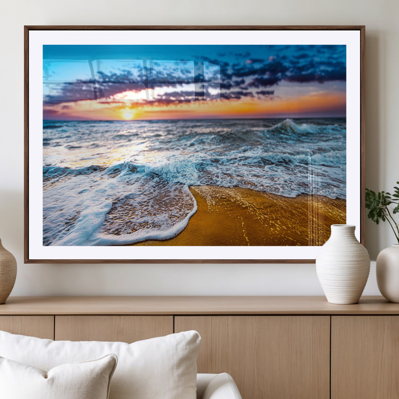 Beautiful ocean shoreline at sunset with foamy waves washing onto golden sand under a colorful sky – Wall Art Canvas Print.