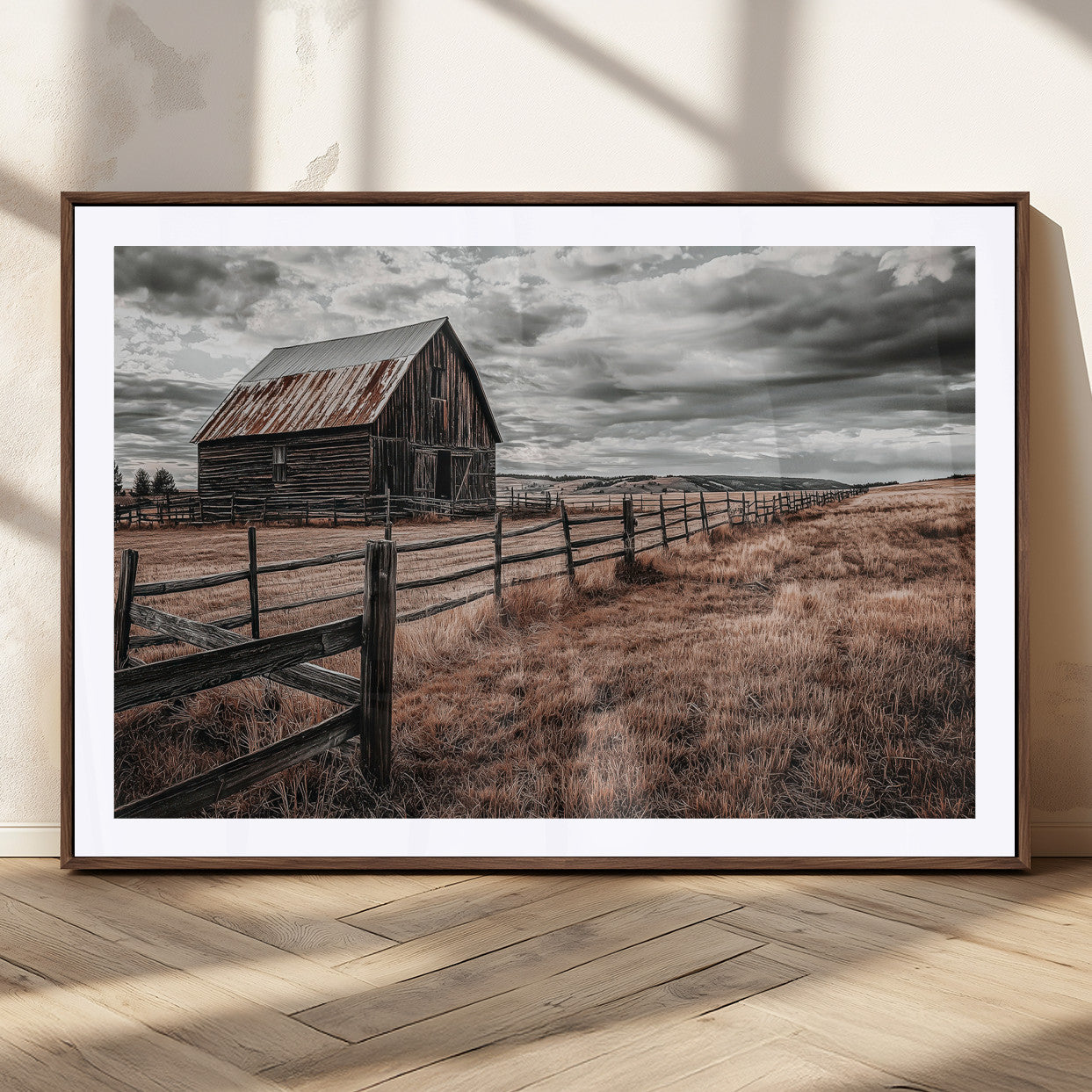 Framed canvas of a rustic barn under a moody sky with weathered fence and dark fields, ideal for farmhouse or rural-style wall decor.