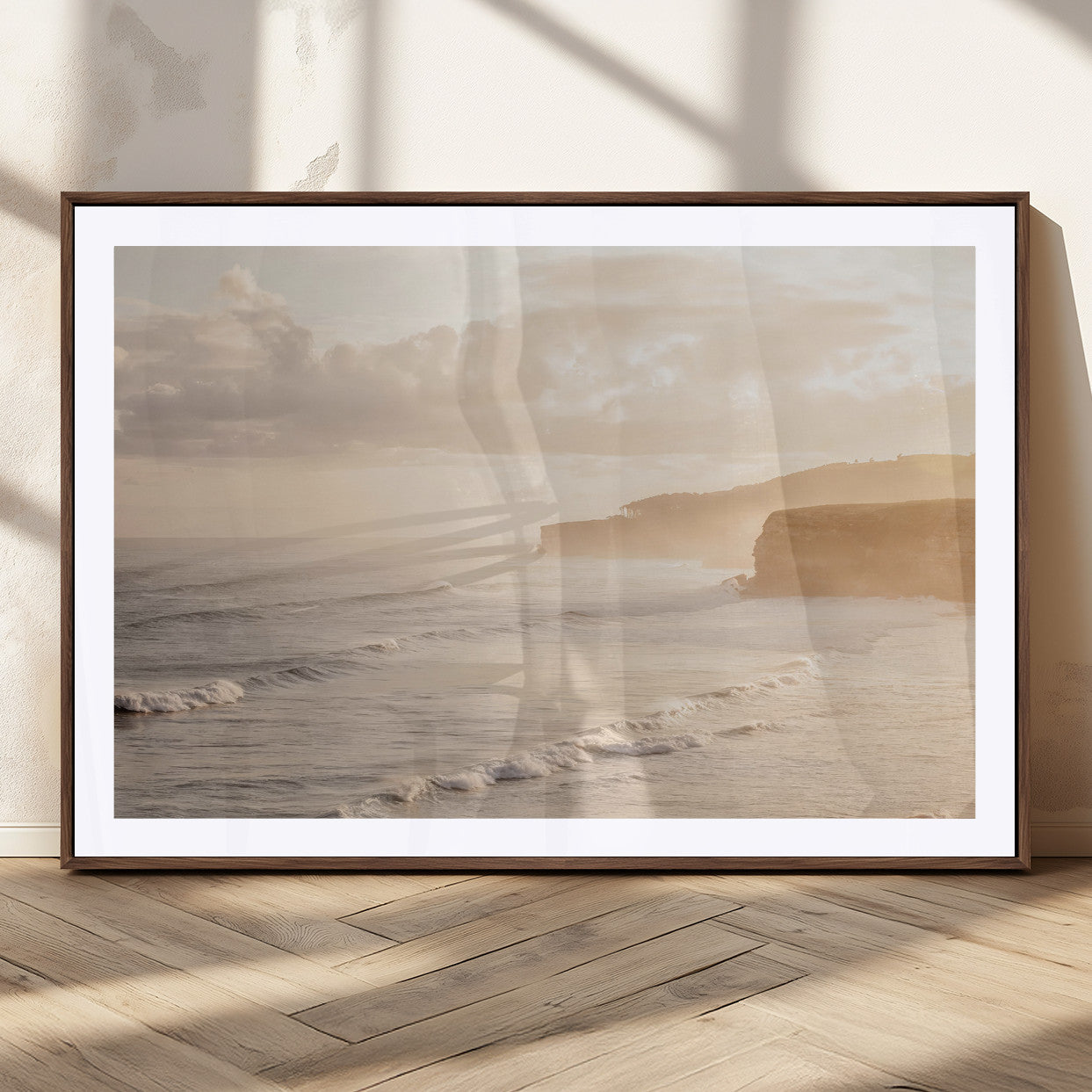 Golden hour seascape with misty cliffs and gentle waves rolling towards the shore, capturing a tranquil and warm coastal atmosphere.