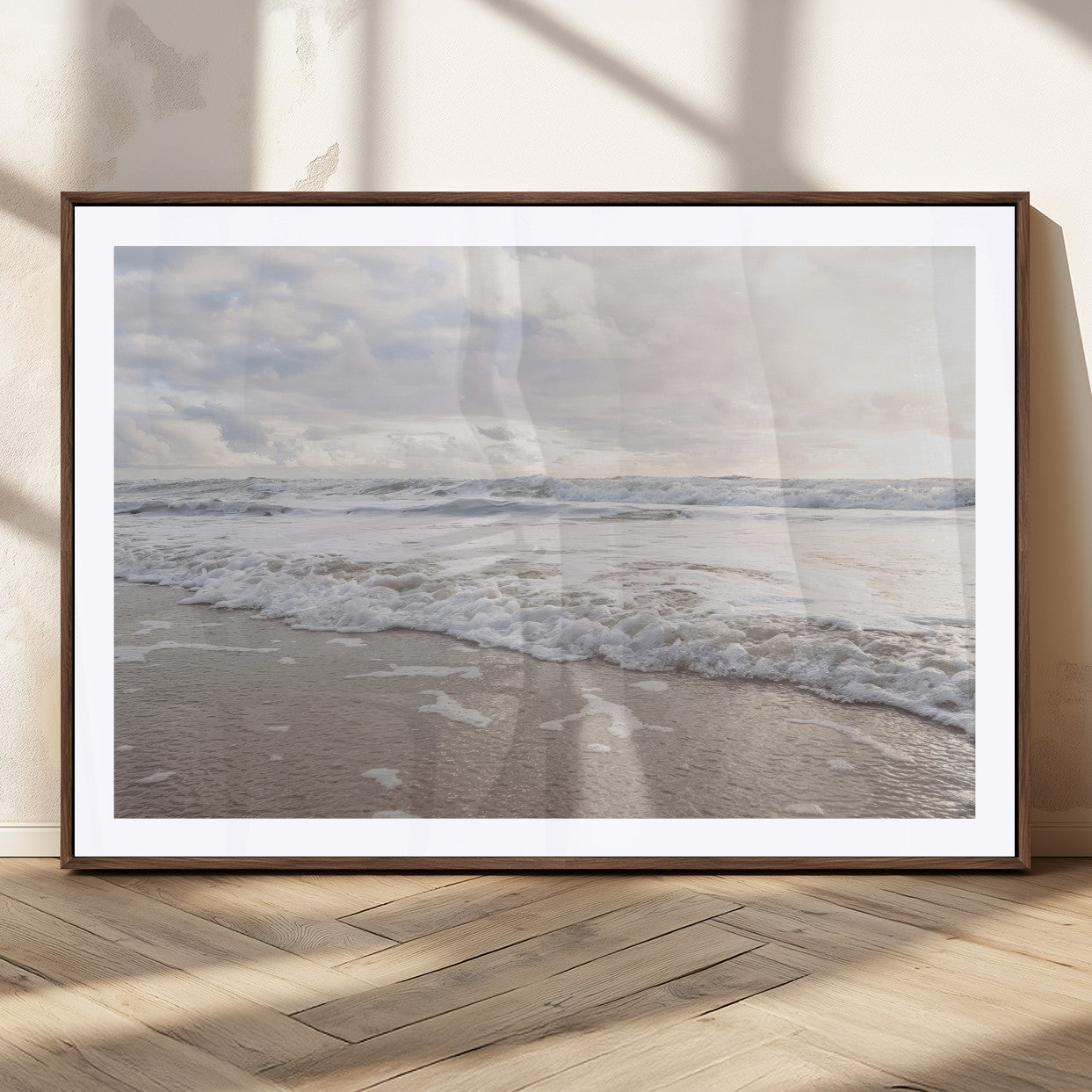 Peaceful ocean waves rolling onto the sandy shore under soft light, perfect for neutral or coastal minimalist decor themes.