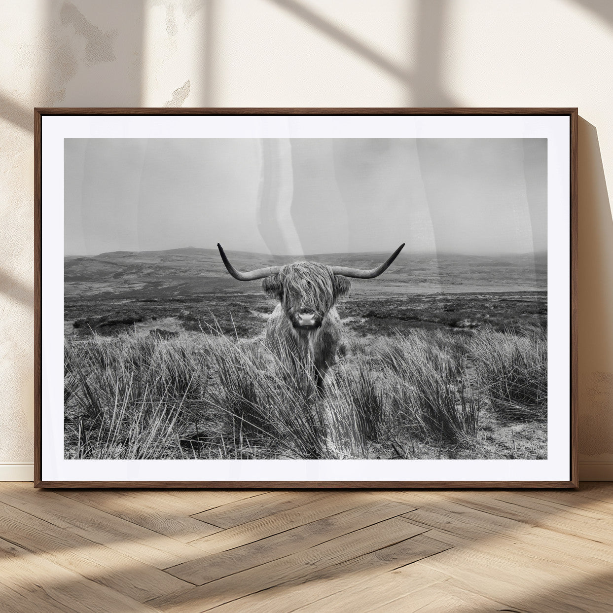 A black and white portrait of a Highland cow in a foggy Scottish countryside, capturing a rustic aesthetic and tranquil farm escape.