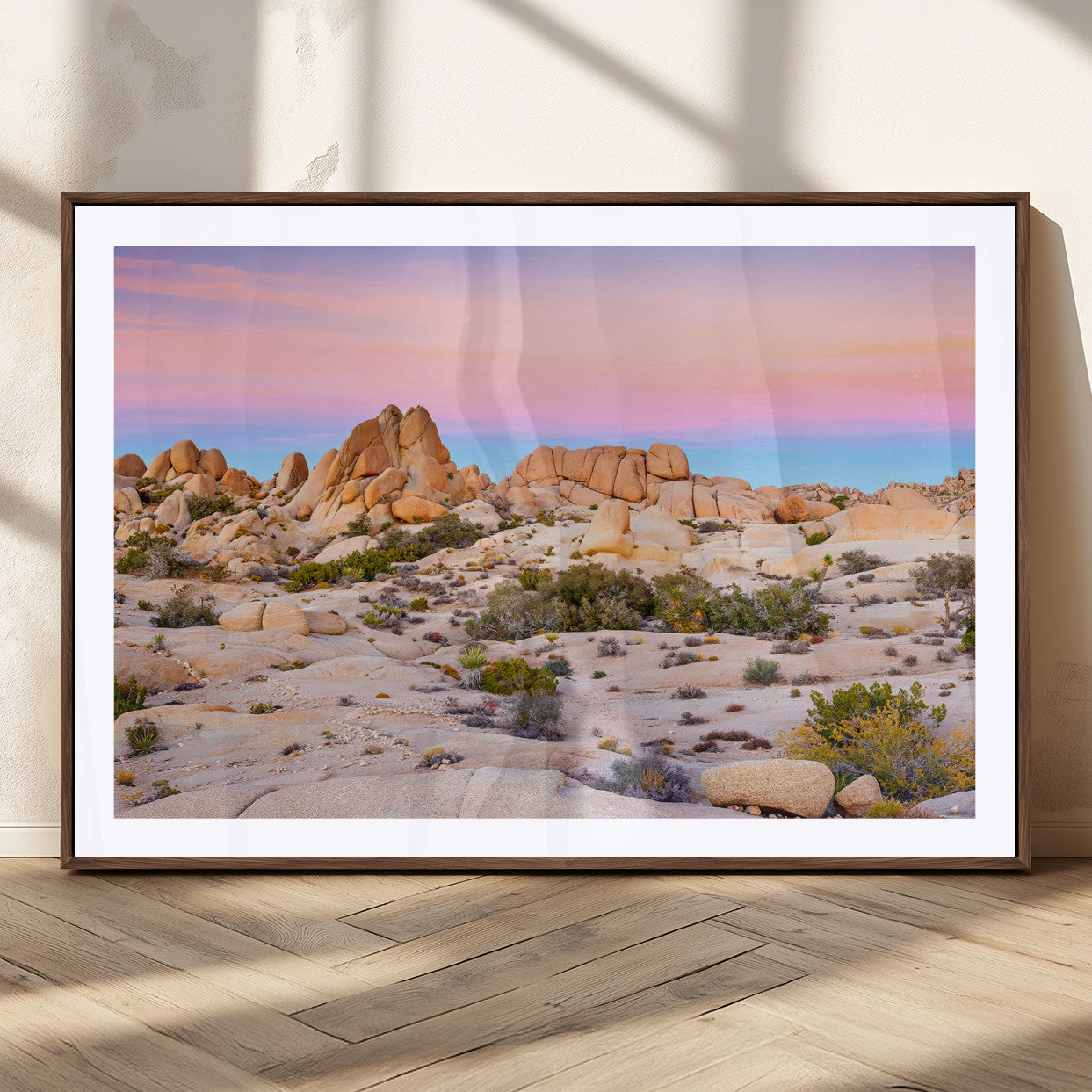 A breathtaking desert landscape featuring rugged rock formations under a vibrant pastel sunset sky, capturing the warmth and serenity of a Southwestern wilderness.