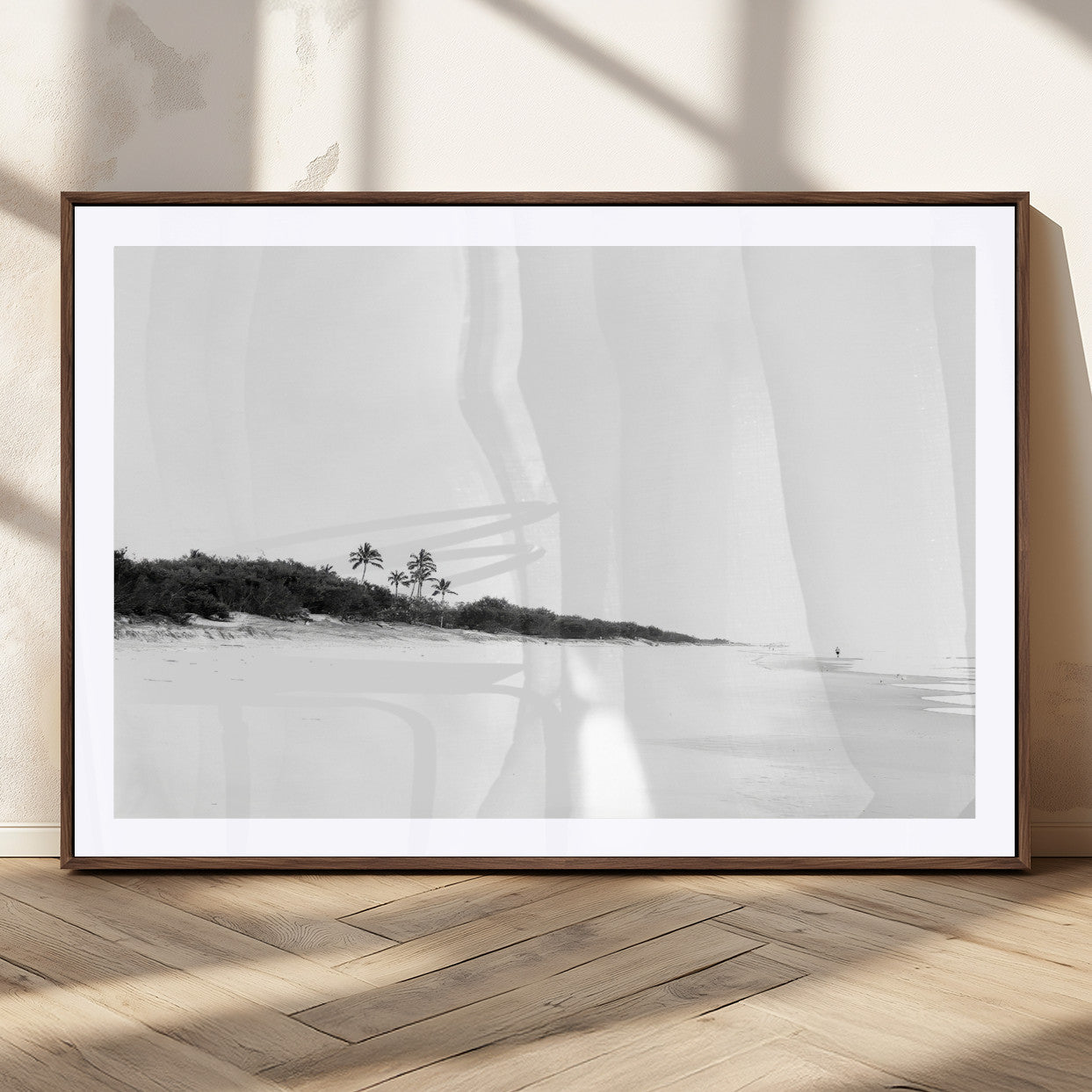 A black and white minimalist coastal scene with a vast open beach, distant palm trees, and a lone figure walking along the shoreline, evoking serenity and solitude.