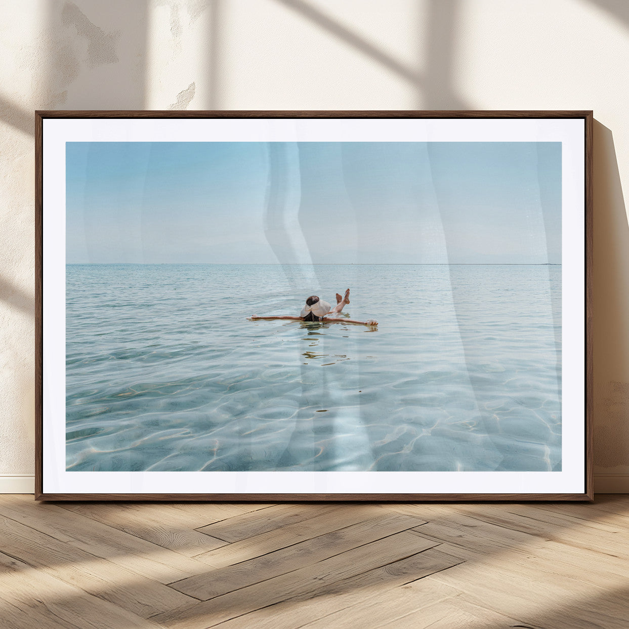 A peaceful minimalist scene of a person floating on crystal-clear water, surrounded by a vast open horizon, capturing relaxation and serenity in a tranquil aquatic setting.