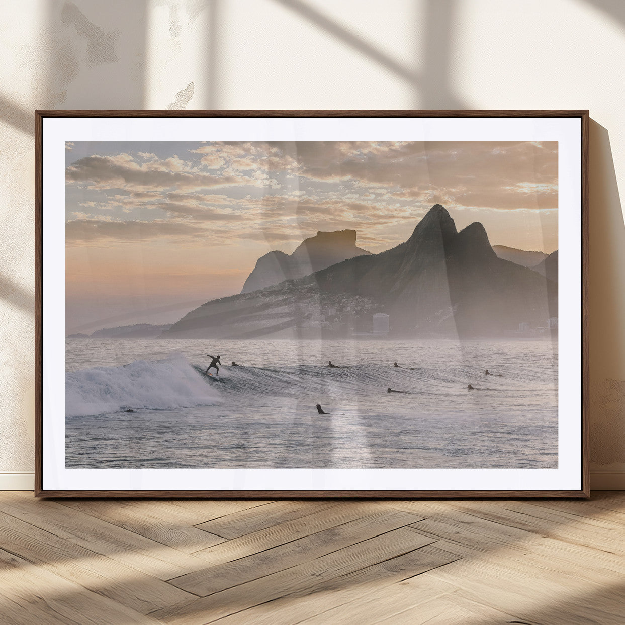 A surfer rides a golden hour wave near misty coastal mountains, surrounded by fellow surfers, capturing the spirit of a coastal adventure.
