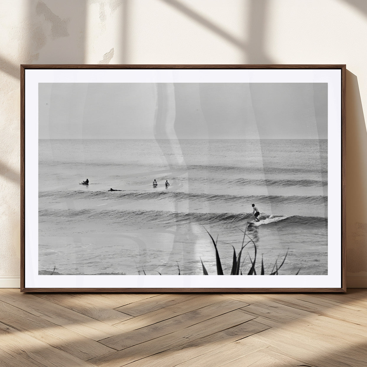 Monochrome canvas of surfers on calm ocean waves, ideal for minimalist coastal or beach-inspired interior decor.