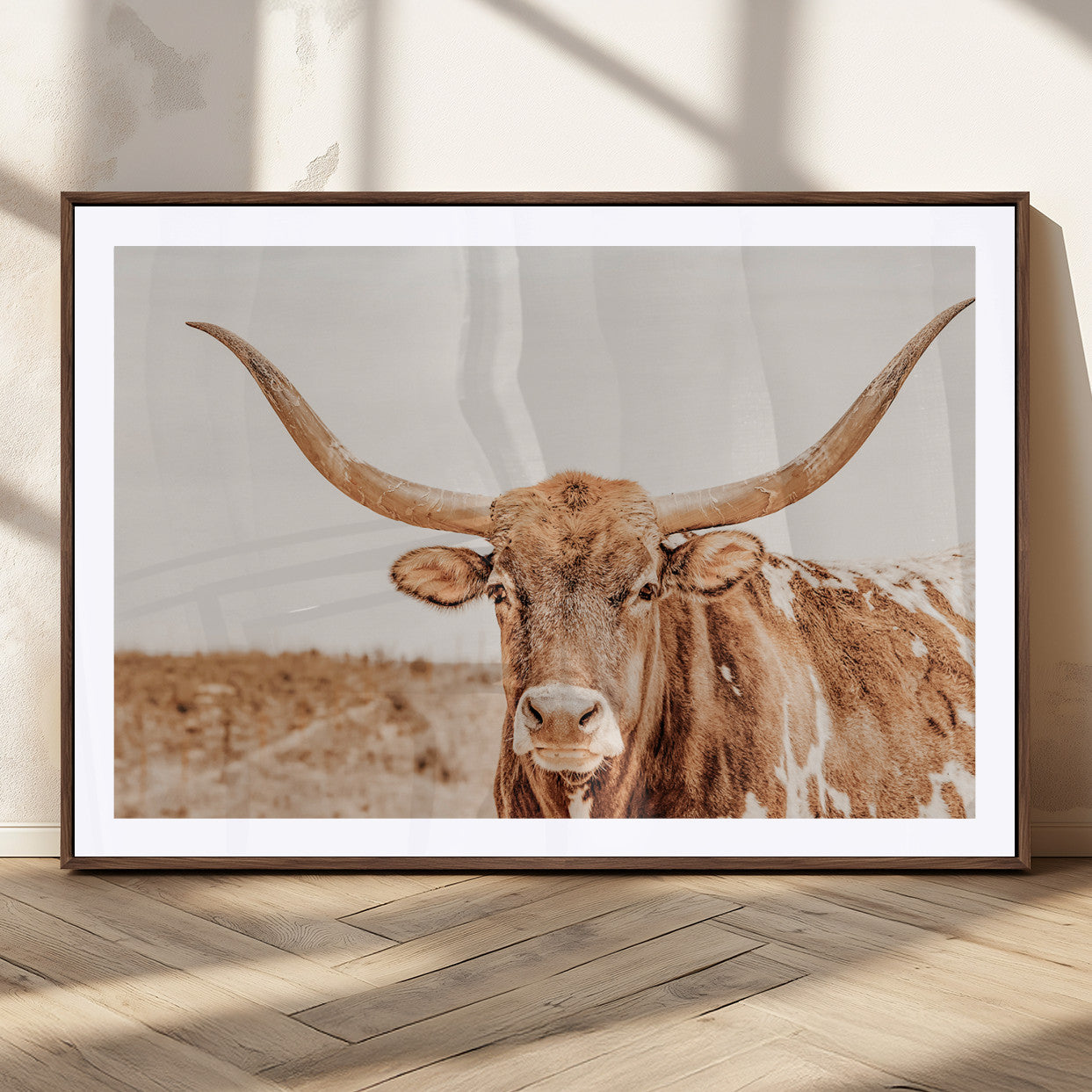 Sepia-toned Texas Longhorn facing forward in a dry field, perfect for rustic farmhouse or western-themed neutral home decor.
