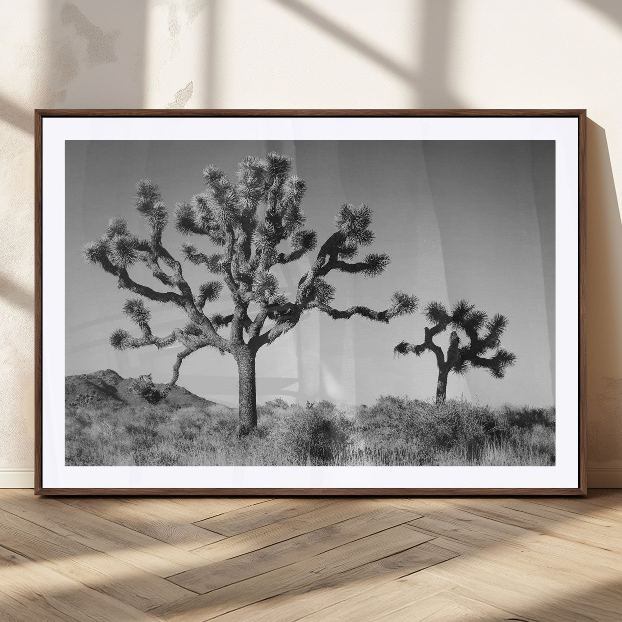 Black and white desert scene with two Joshua trees under clear sky, perfect for rustic or boho-inspired home decor.