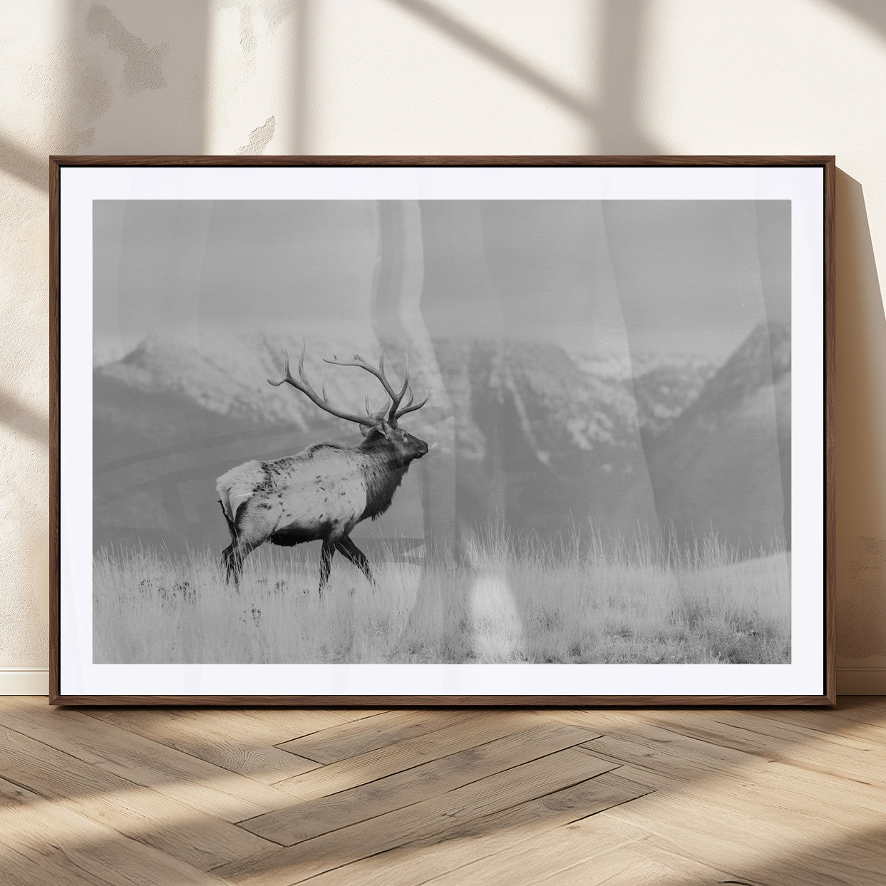 Black and white elk standing in front of snowy mountain range, perfect for rustic lodge or nature-inspired wall decor.