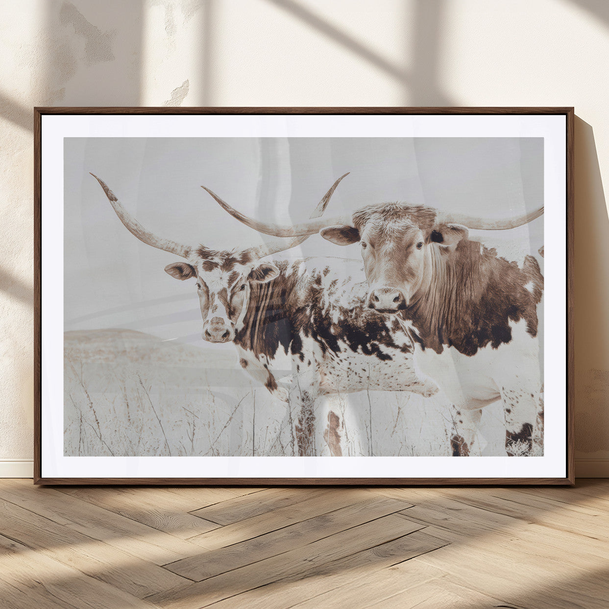Two longhorn cows standing in a sepia-toned pasture with soft light, ideal for rustic or farmhouse-themed neutral wall decor.
