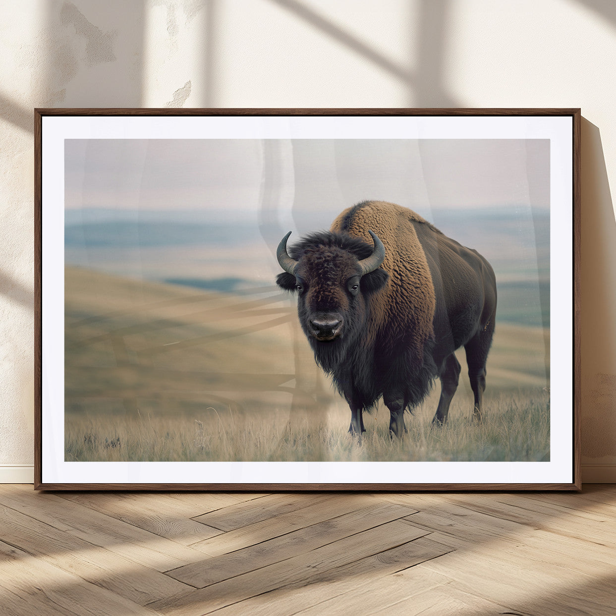 A bison standing strong on a grassy prairie with rolling hills in the background, perfect for rustic and Western-inspired wall decor.