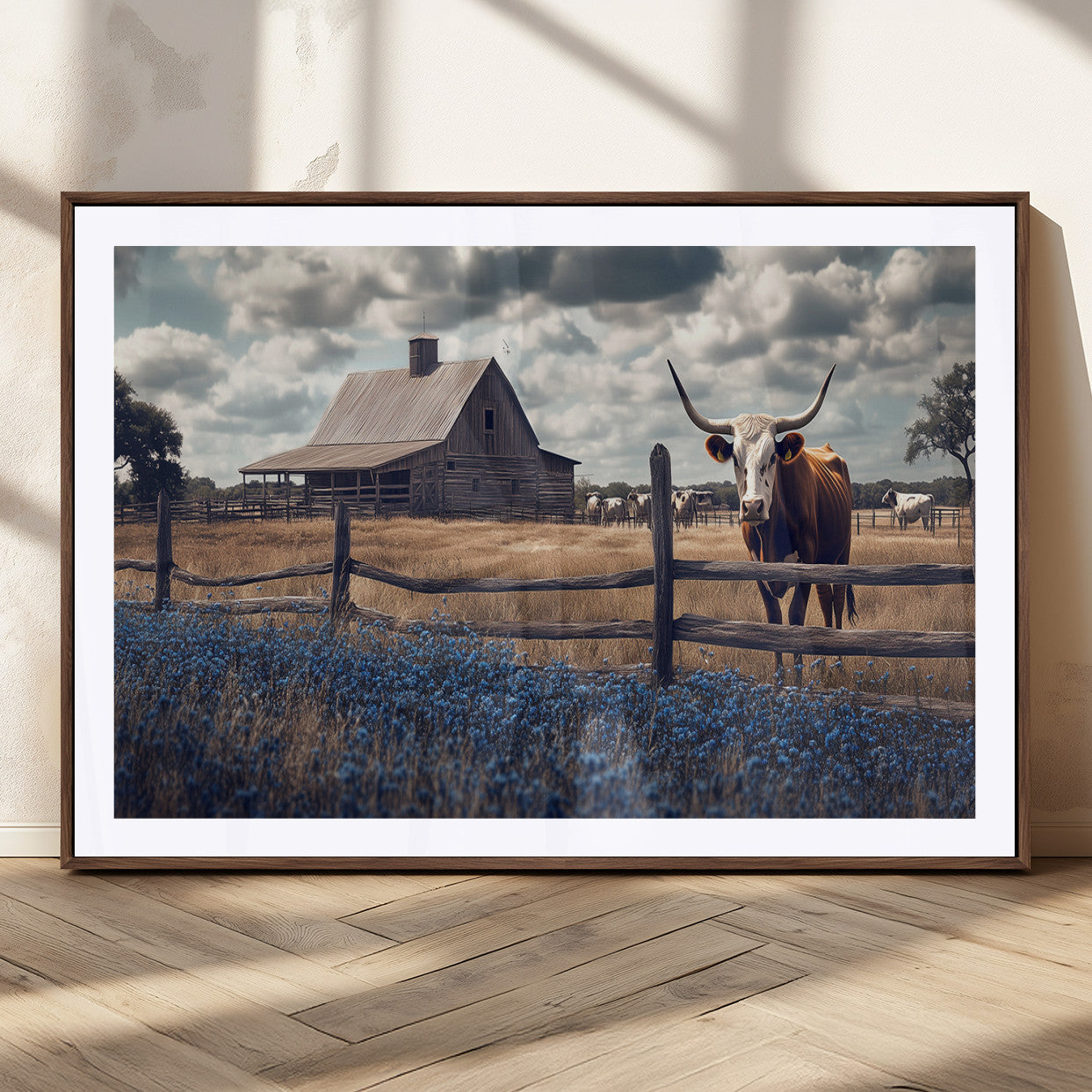 Framed canvas art of a Texas Longhorn cow near a rustic barn and bluebonnet field, ideal for country-style or farmhouse wall decor.