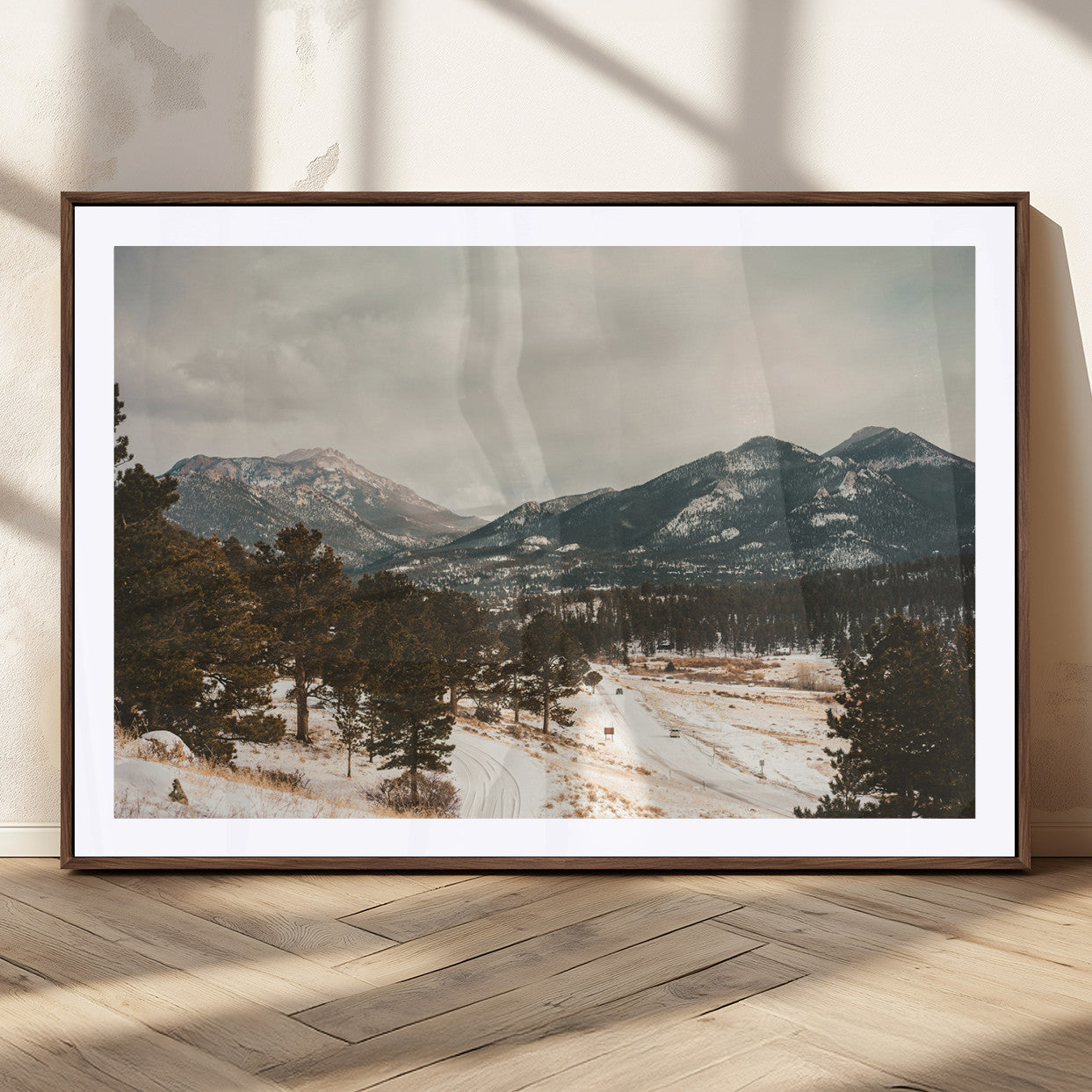 Snow-covered mountains with pine trees and a winding path, creating a serene and rustic winter landscape perfect for cozy decor.