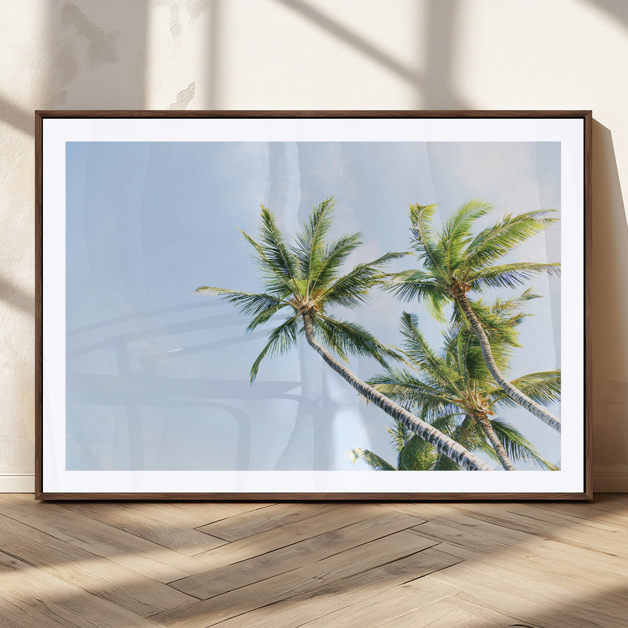 Tall palm trees swaying under a bright blue sky, capturing a tropical and minimalist beach vibe, perfect for coastal-inspired wall art.