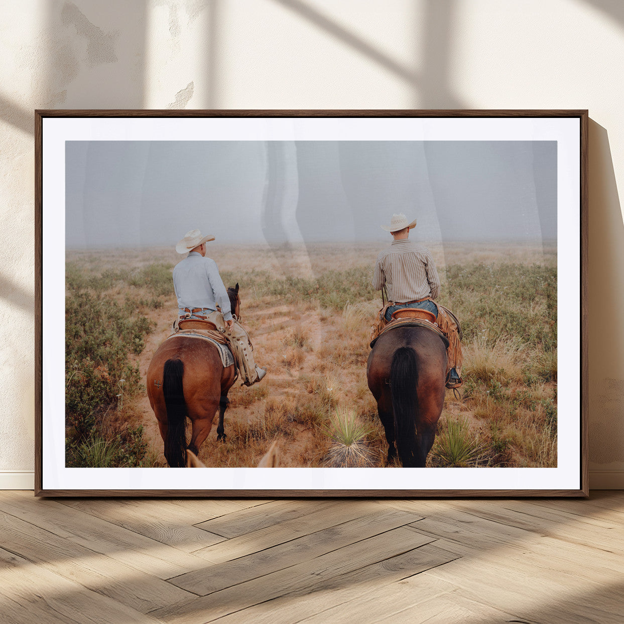 Two cowboys riding horseback through a misty prairie, capturing the rustic and adventurous spirit of the Western frontier.