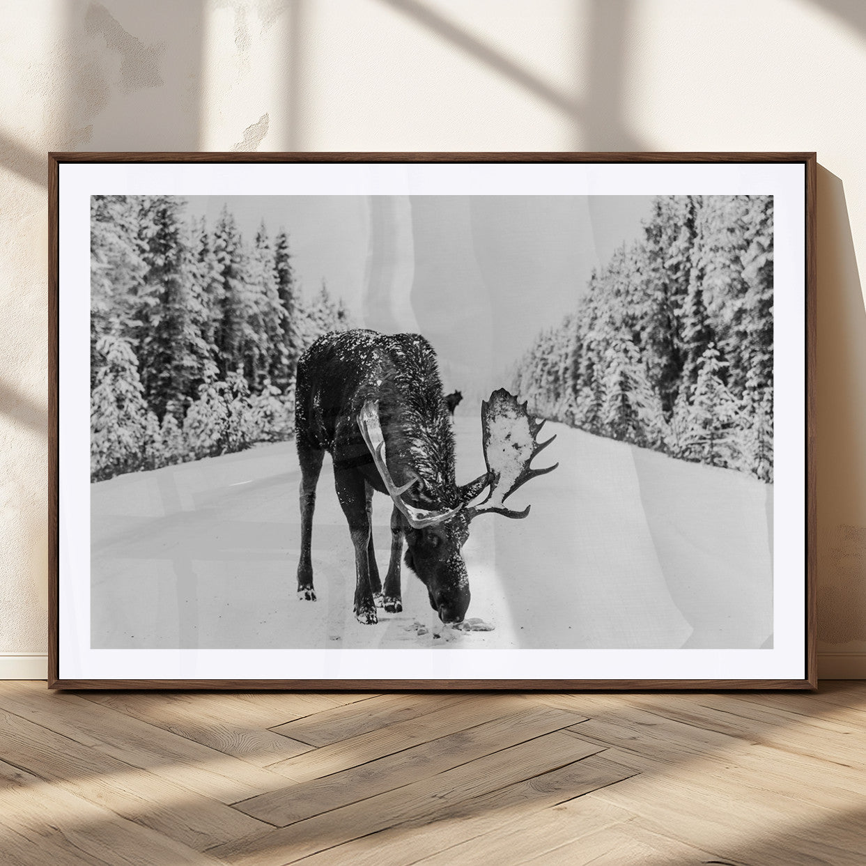 A majestic moose grazing in the snow-covered wilderness, surrounded by snow-covered trees, creating a peaceful winter scene.