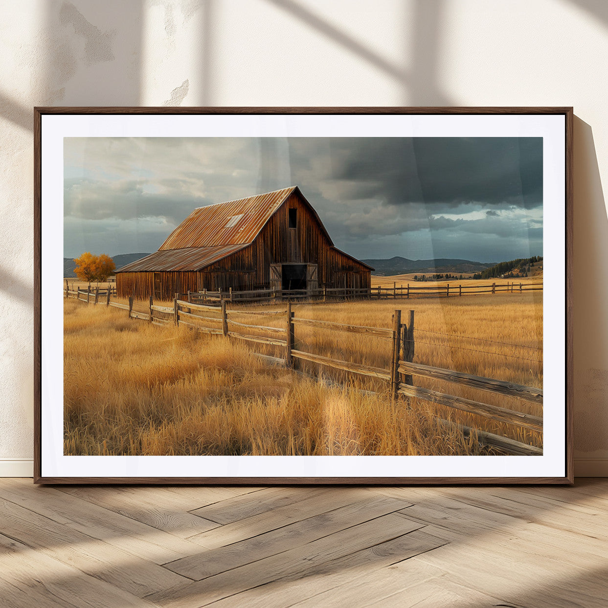 "Golden fields surrounding a rustic barn with a weathered roof, a wooden fence, and dramatic skies with sunlight breaking through the clouds."