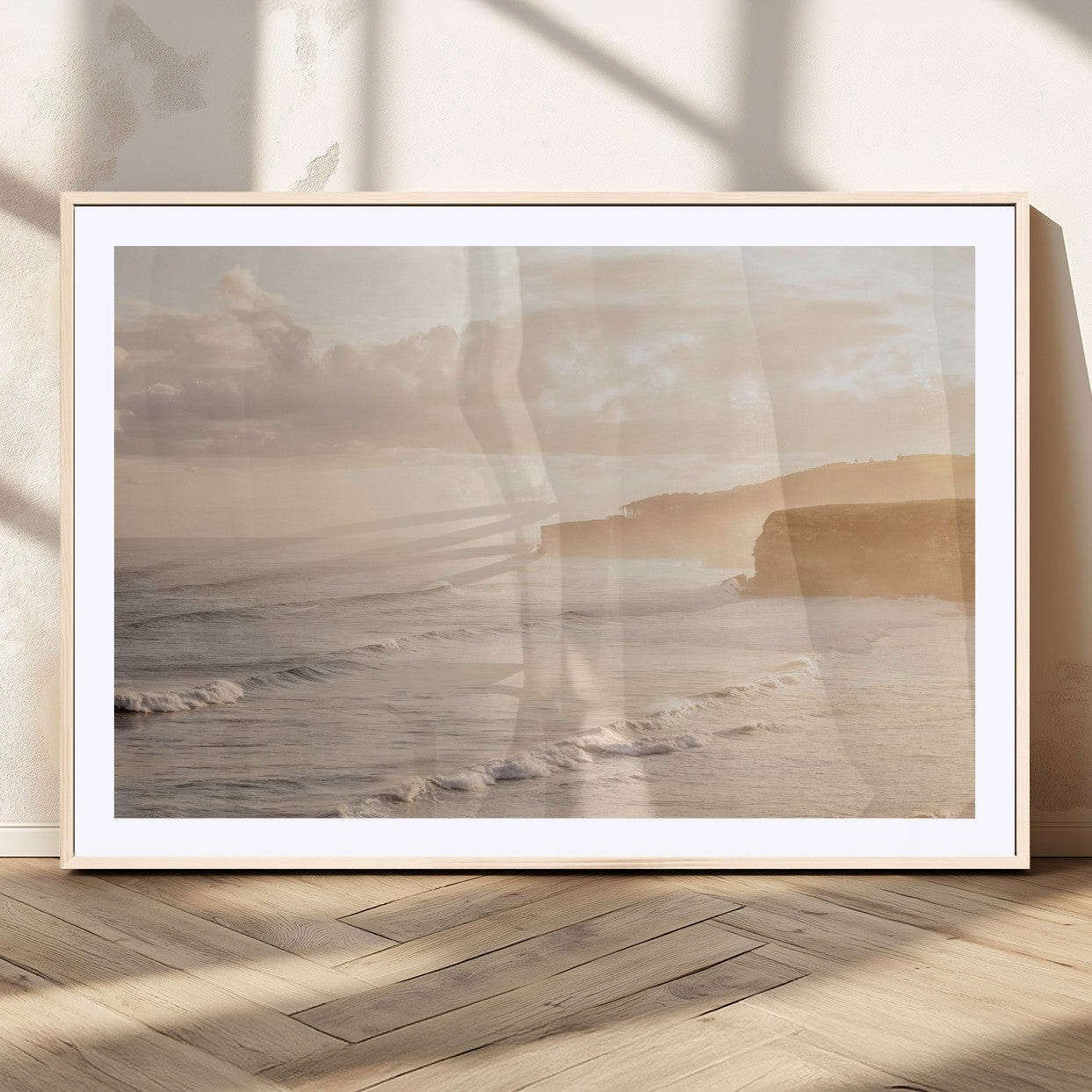 Golden hour seascape with misty cliffs and gentle waves rolling towards the shore, capturing a tranquil and warm coastal atmosphere.
