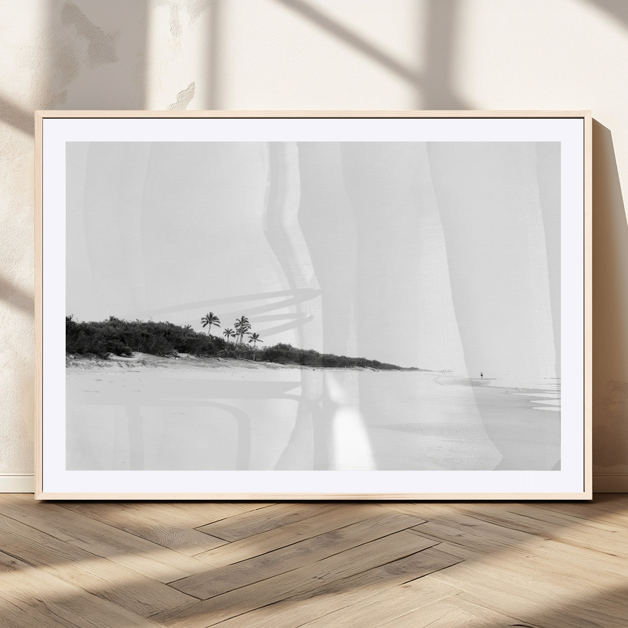 A black and white minimalist coastal scene with a vast open beach, distant palm trees, and a lone figure walking along the shoreline, evoking serenity and solitude.