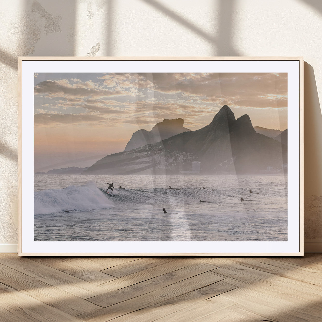 A surfer rides a golden hour wave near misty coastal mountains, surrounded by fellow surfers, capturing the spirit of a coastal adventure.