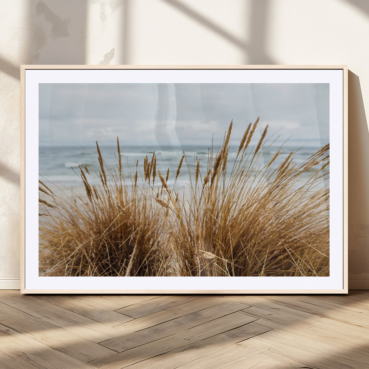 Canvas of golden beach grass swaying by the ocean under a soft cloudy sky, perfect for neutral-toned or coastal minimalist decor.