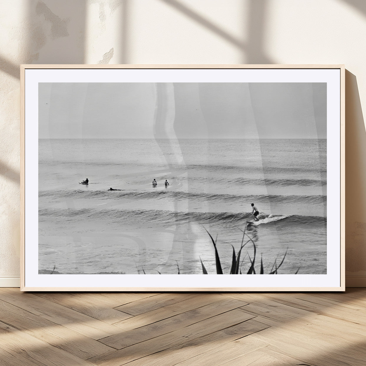 Monochrome canvas of surfers on calm ocean waves, ideal for minimalist coastal or beach-inspired interior decor.