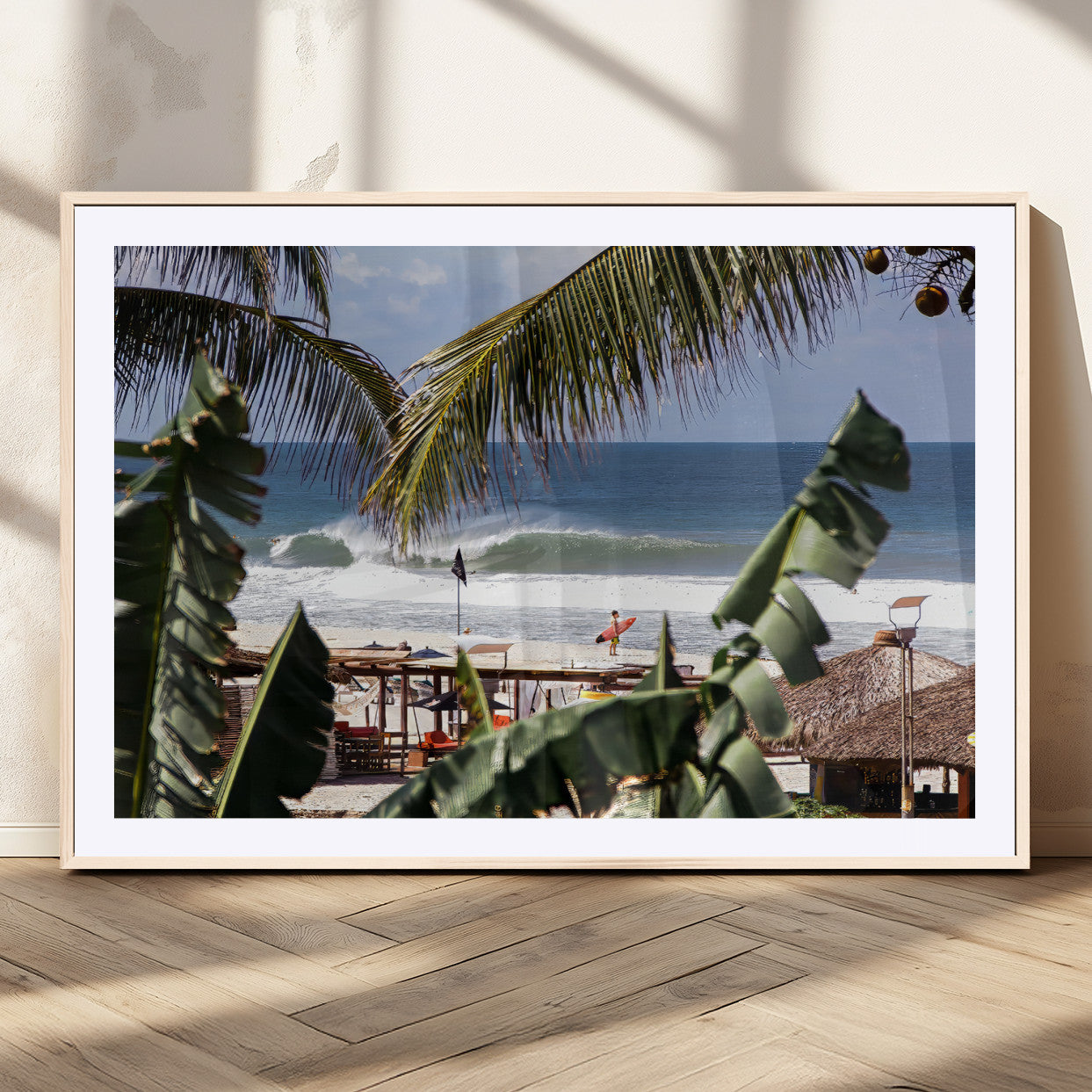 Canvas wall art of a tropical surf scene framed by palm trees, with a surfer on the shore and waves rolling in, ideal for beach-themed decor.