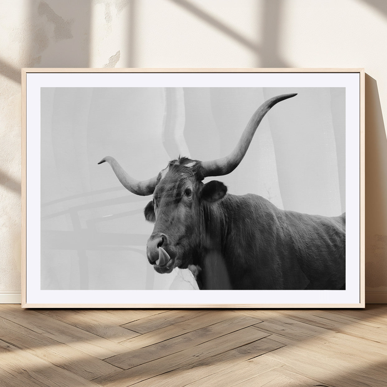 Black and white photo of a Texas Longhorn cow with curved horns, ideal for rustic, western or minimalist style home decor.
