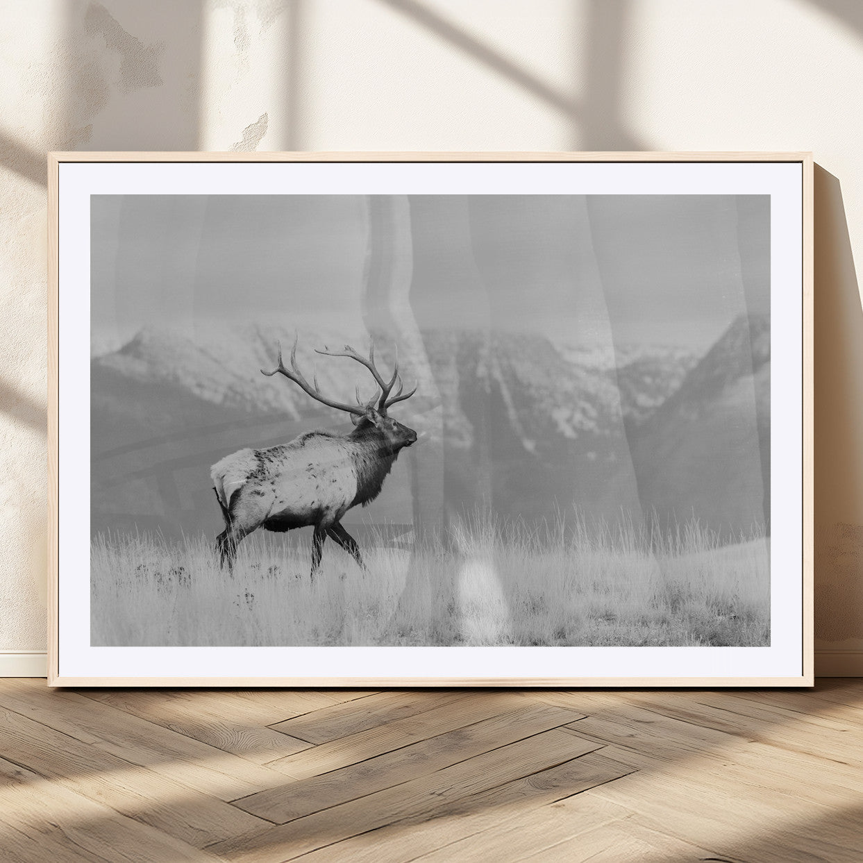 Black and white elk standing in front of snowy mountain range, perfect for rustic lodge or nature-inspired wall decor.