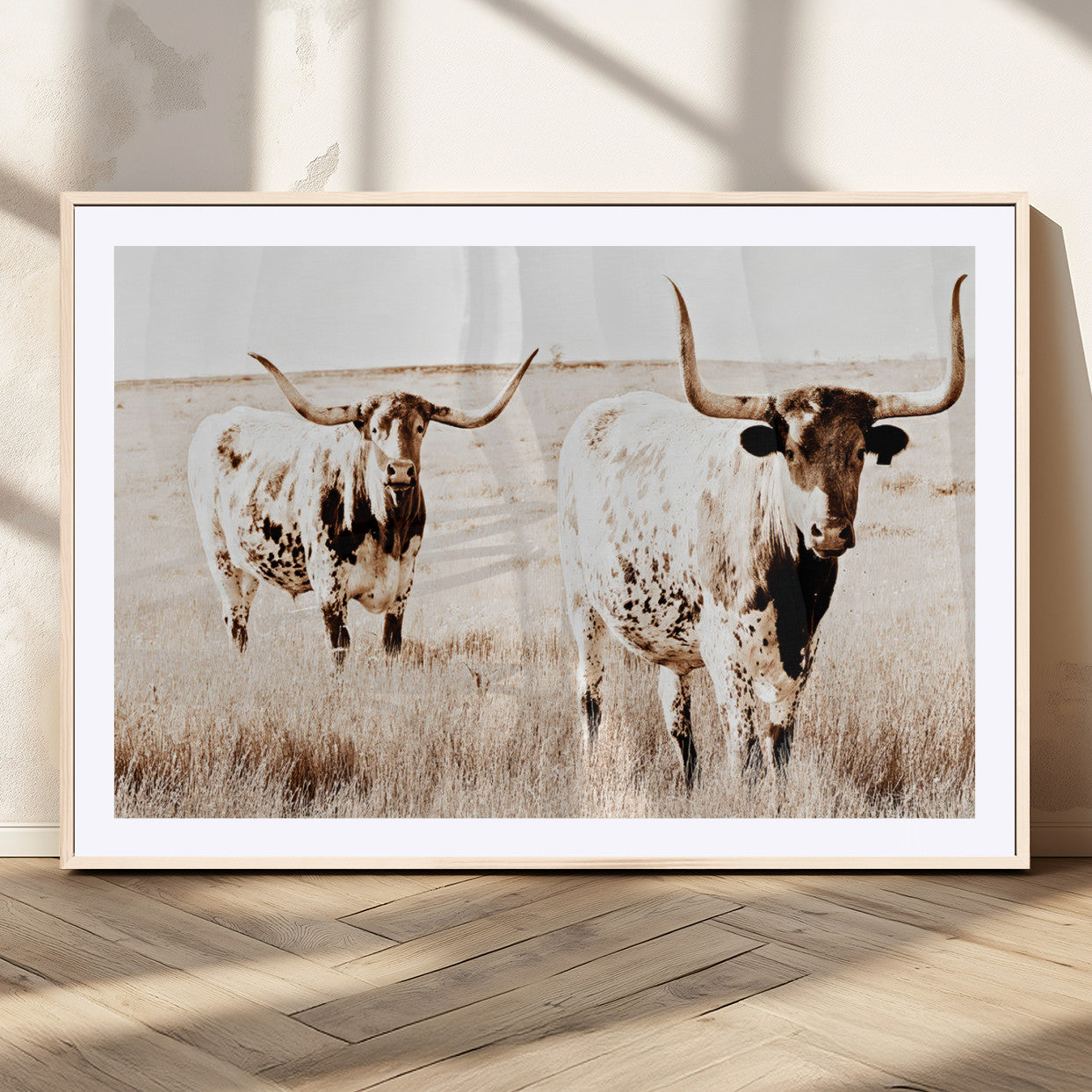 Two Texas longhorn cows standing in a sepia-toned pasture, evoking rustic charm perfect for farmhouse or western country interiors. (