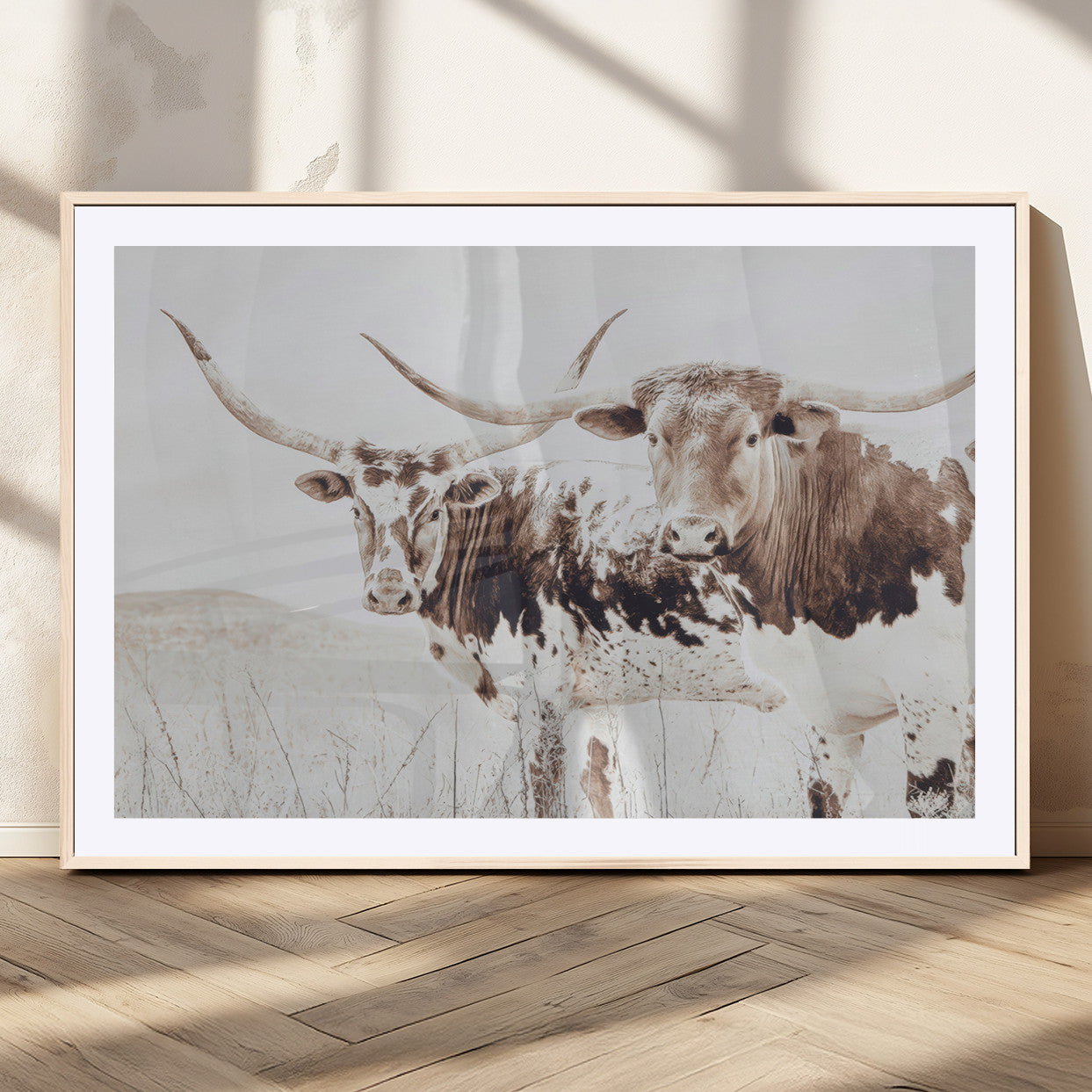 Two longhorn cows standing in a sepia-toned pasture with soft light, ideal for rustic or farmhouse-themed neutral wall decor.