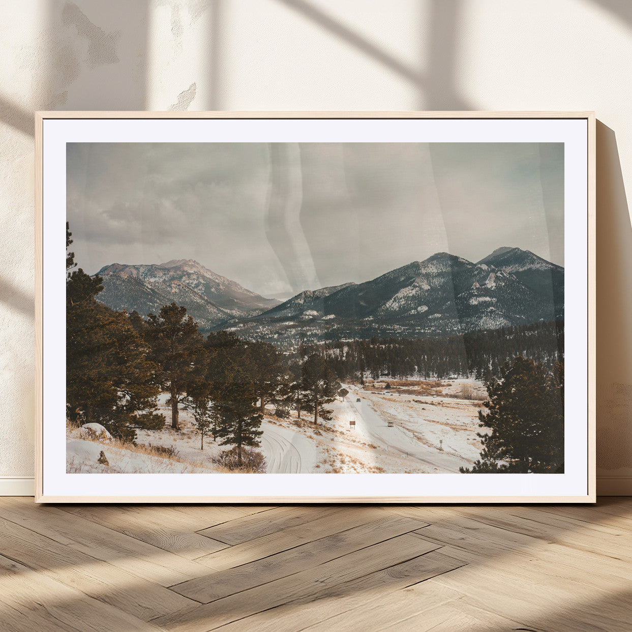 Snow-covered mountains with pine trees and a winding path, creating a serene and rustic winter landscape perfect for cozy decor.