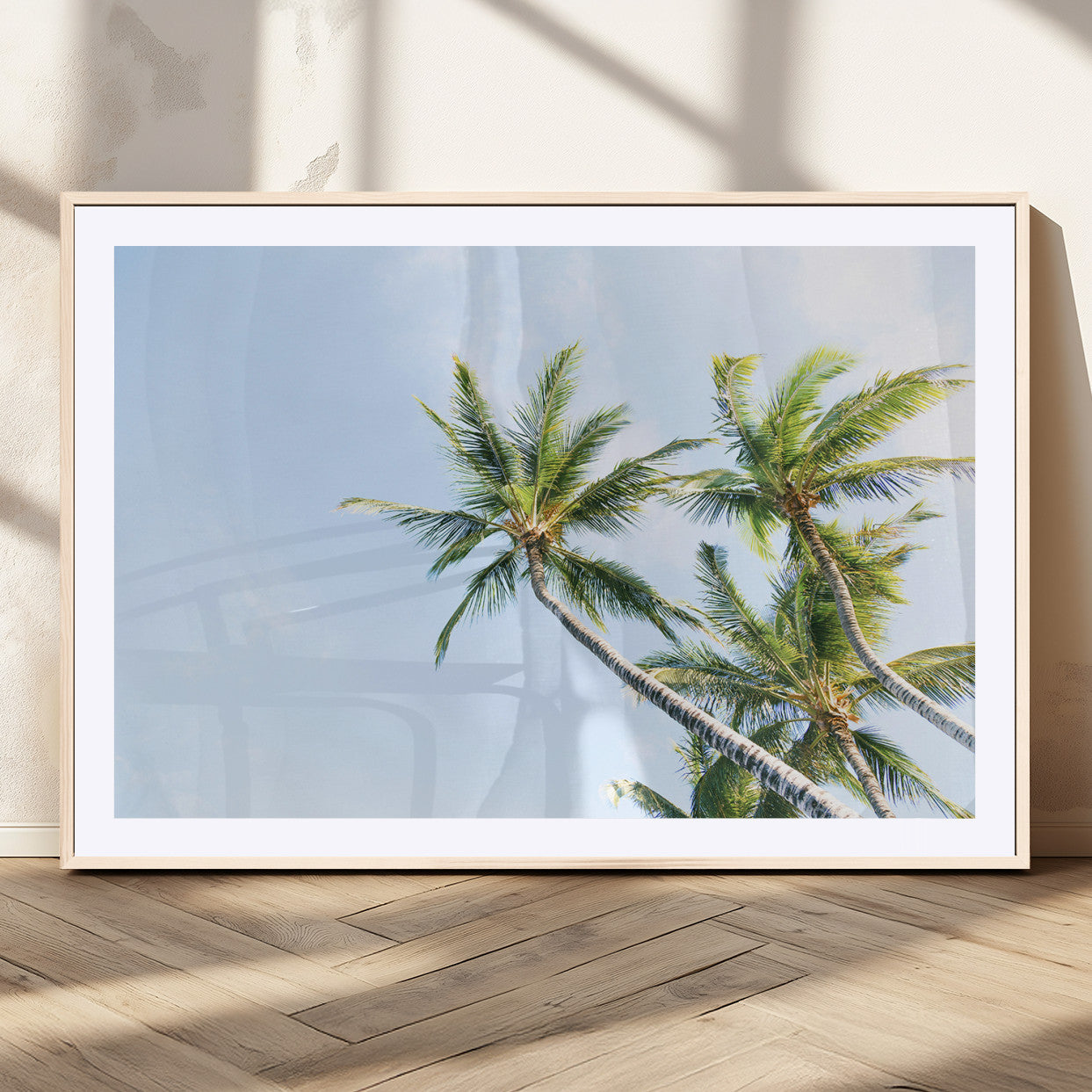 Tall palm trees swaying under a bright blue sky, capturing a tropical and minimalist beach vibe, perfect for coastal-inspired wall art.