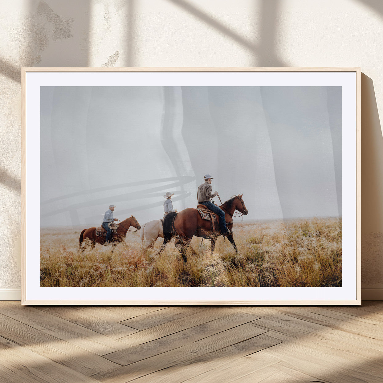 Three cowboys riding horses through a foggy prairie landscape, dressed in Western attire, evoking a rustic and adventurous Wild West aesthetic.