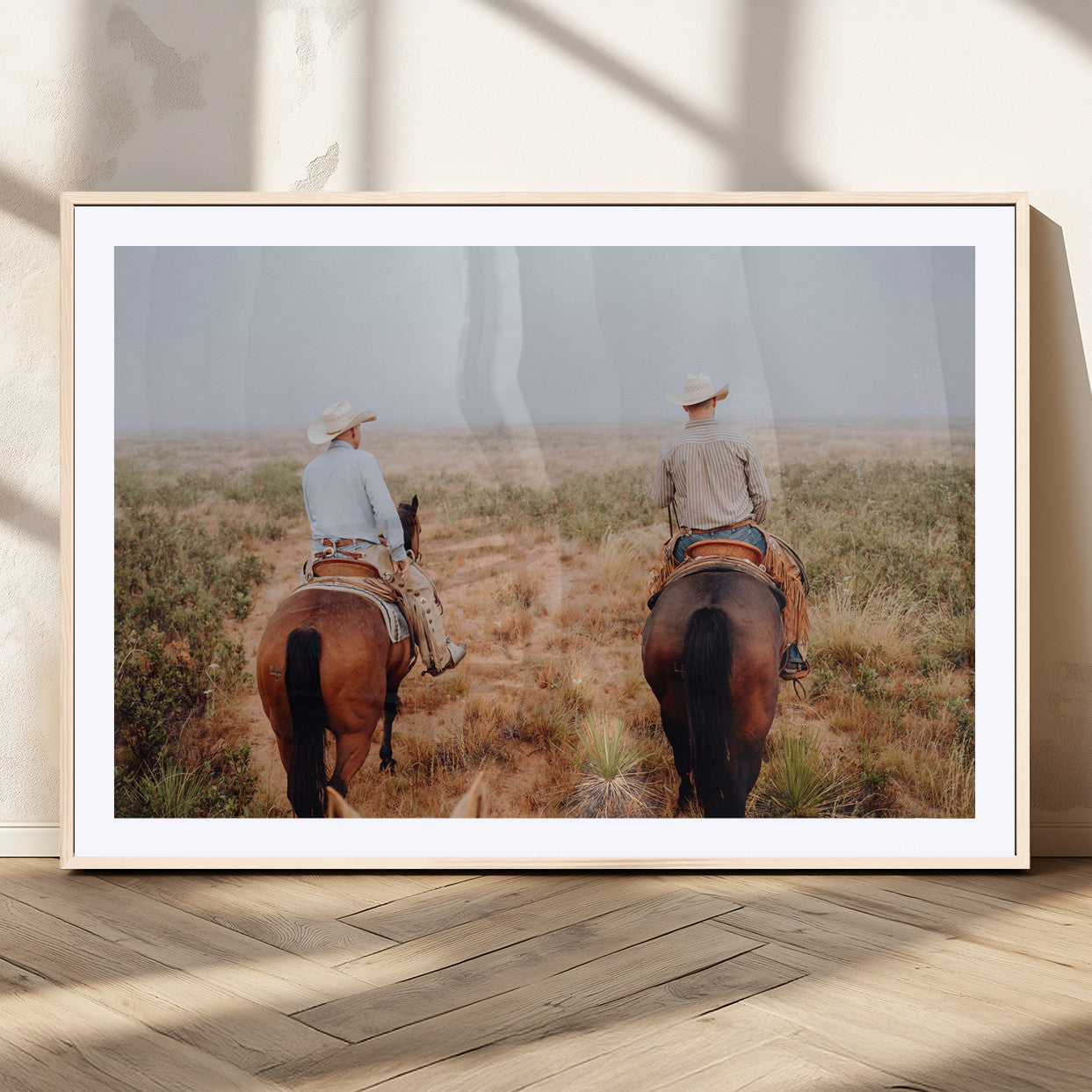 Two cowboys riding horseback through a misty prairie, capturing the rustic and adventurous spirit of the Western frontier.