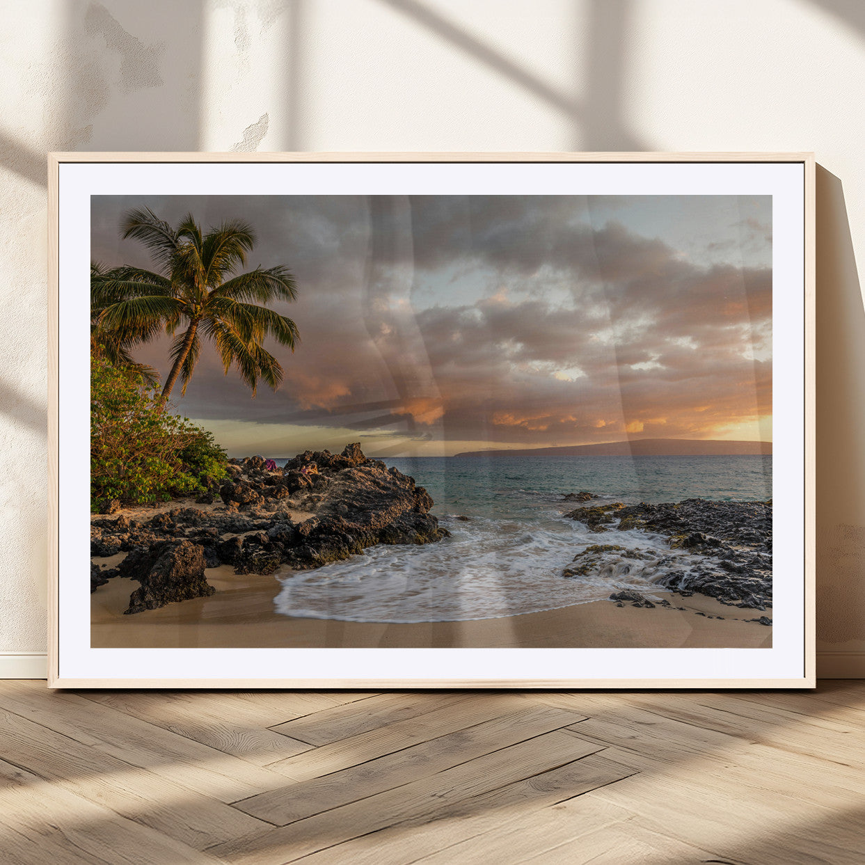 Golden sunset over a tropical beach with palm trees, rocky shoreline, and gentle ocean waves, perfect for coastal and island-inspired decor.