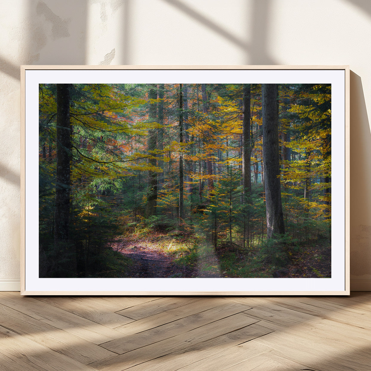 A serene autumn forest with golden and green leaves, a misty atmosphere, and a sunlit pathway, creating a tranquil nature-inspired wall art piece.