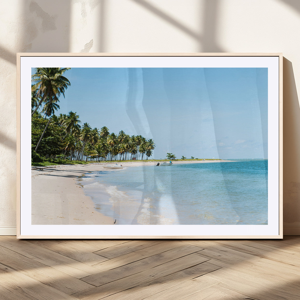 A serene tropical beach with clear blue water, soft sand, and lush palm trees under a bright sky, creating a peaceful island paradise atmosphere.