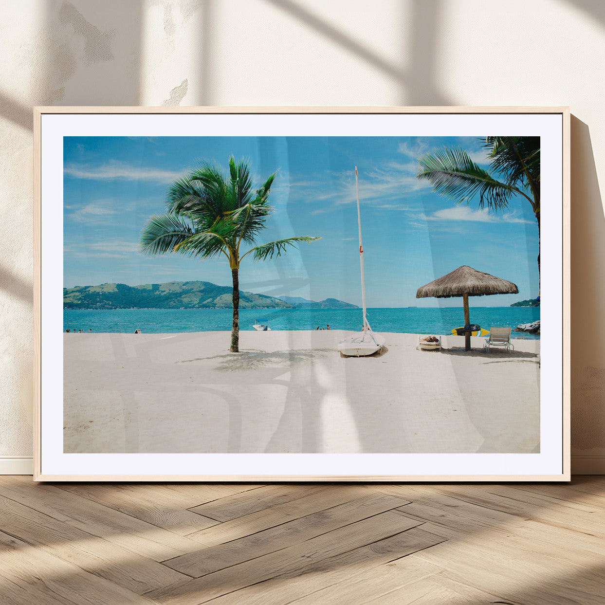 Tropical beach scene with palm trees, a white sailboat, and turquoise ocean waters under a bright blue sky, creating a peaceful summer vibe.