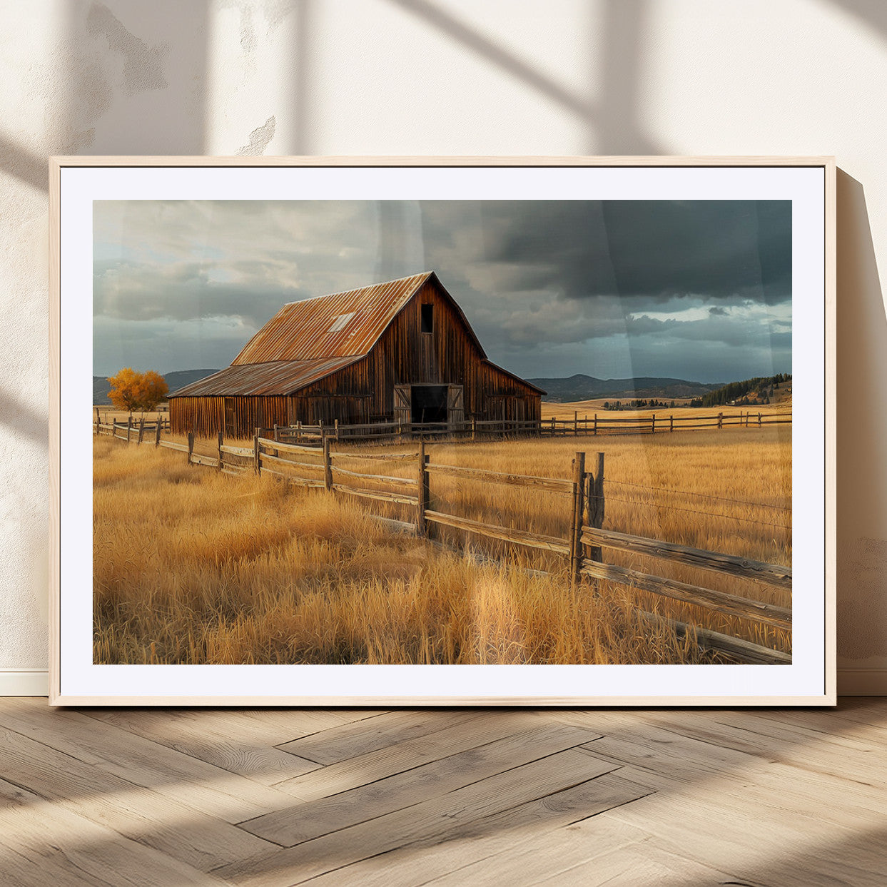 "Golden fields surrounding a rustic barn with a weathered roof, a wooden fence, and dramatic skies with sunlight breaking through the clouds."