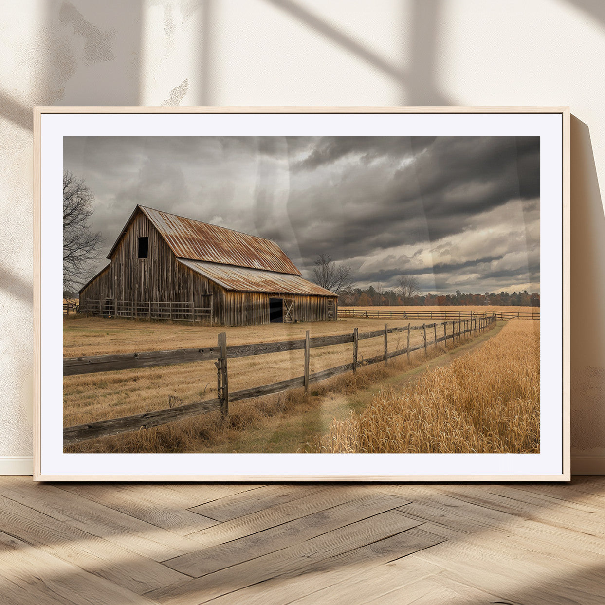"Rustic barn with a weathered metal roof, surrounded by a wooden fence and golden fields under an overcast sky with dramatic clouds."