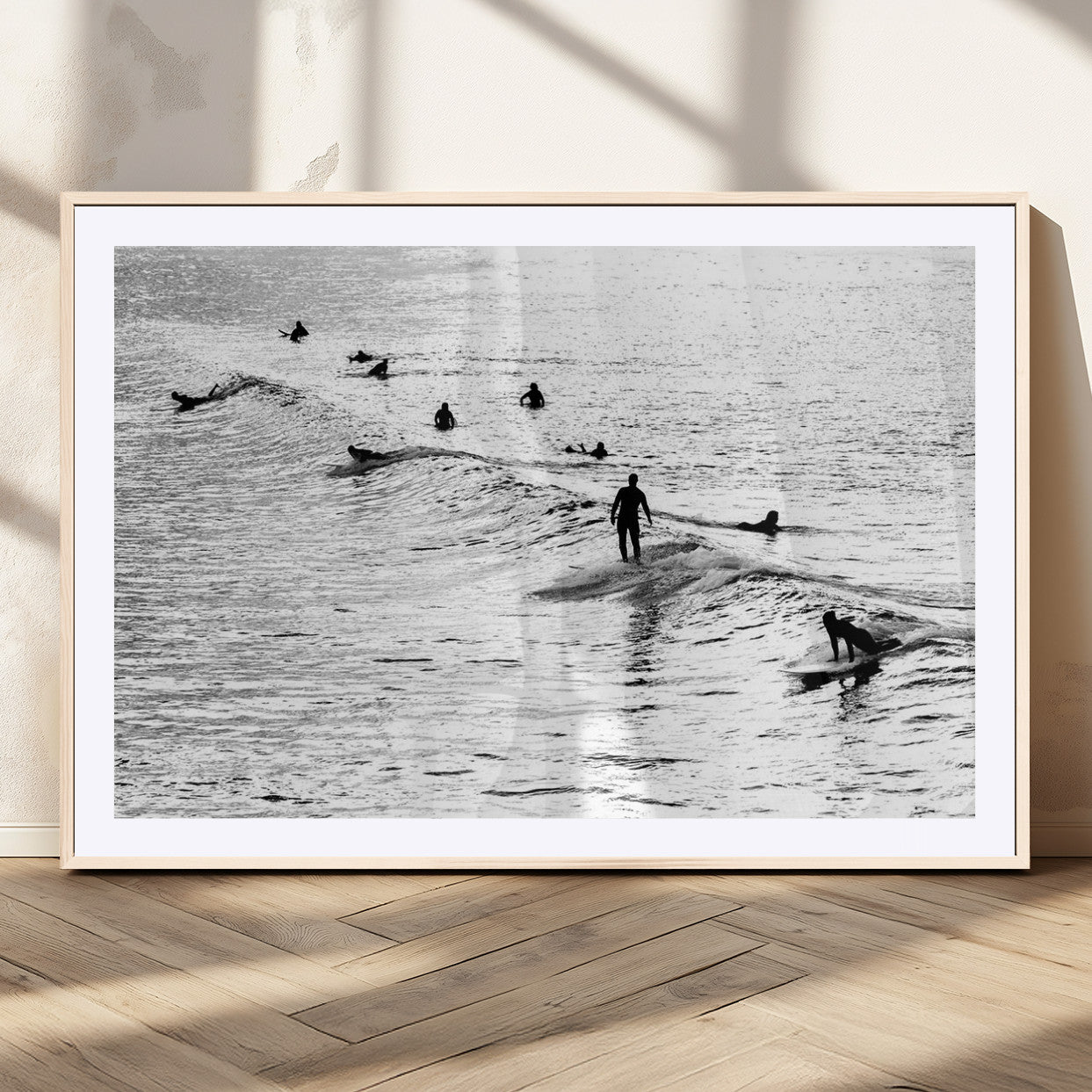 19970637-MGV-CV-36X24-Black and white artistic view of surfers riding and paddling on waves in the ocean, capturing the dynamic motion and energy of surfing