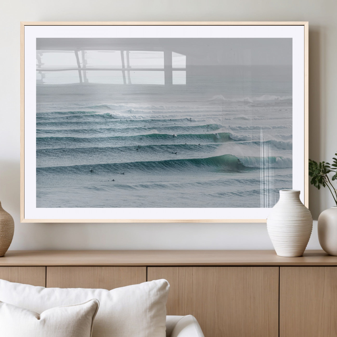 High-angle view of surfers lining up across layered ocean waves, ideal for minimal coastal or surf-inspired room decor.