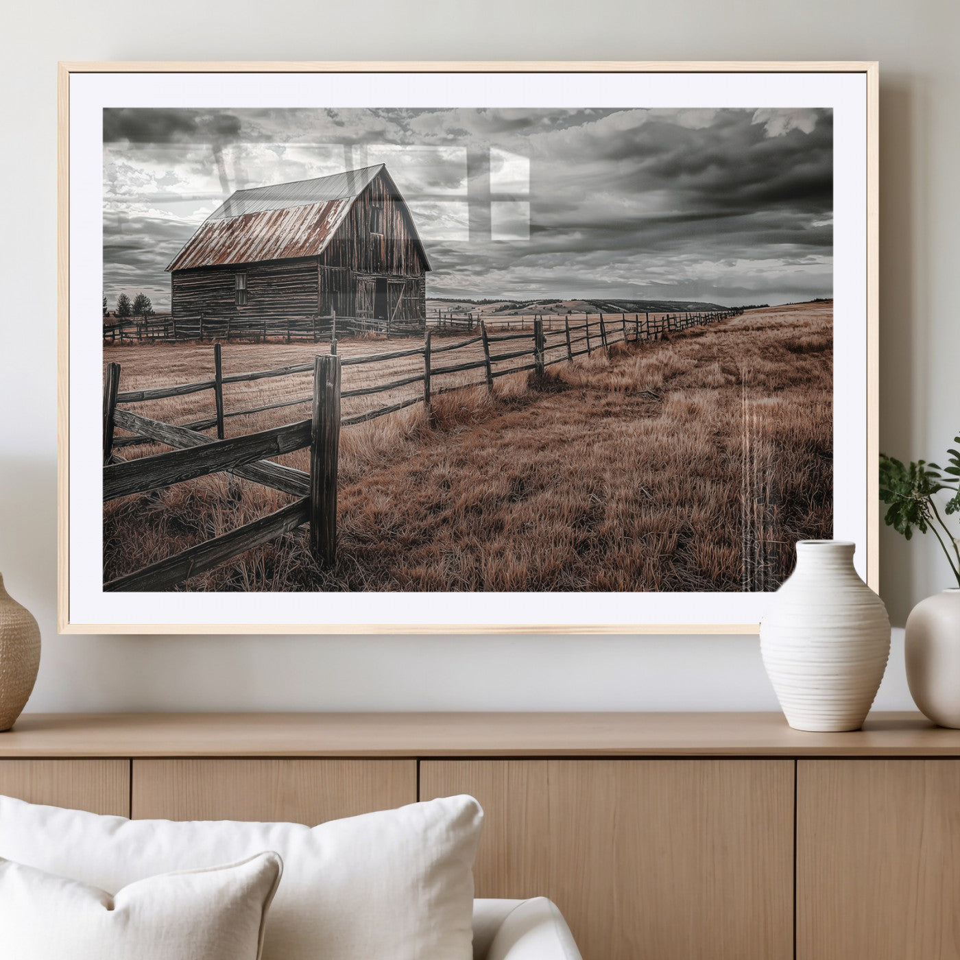 Framed canvas of a rustic barn under a moody sky with weathered fence and dark fields, ideal for farmhouse or rural-style wall decor.