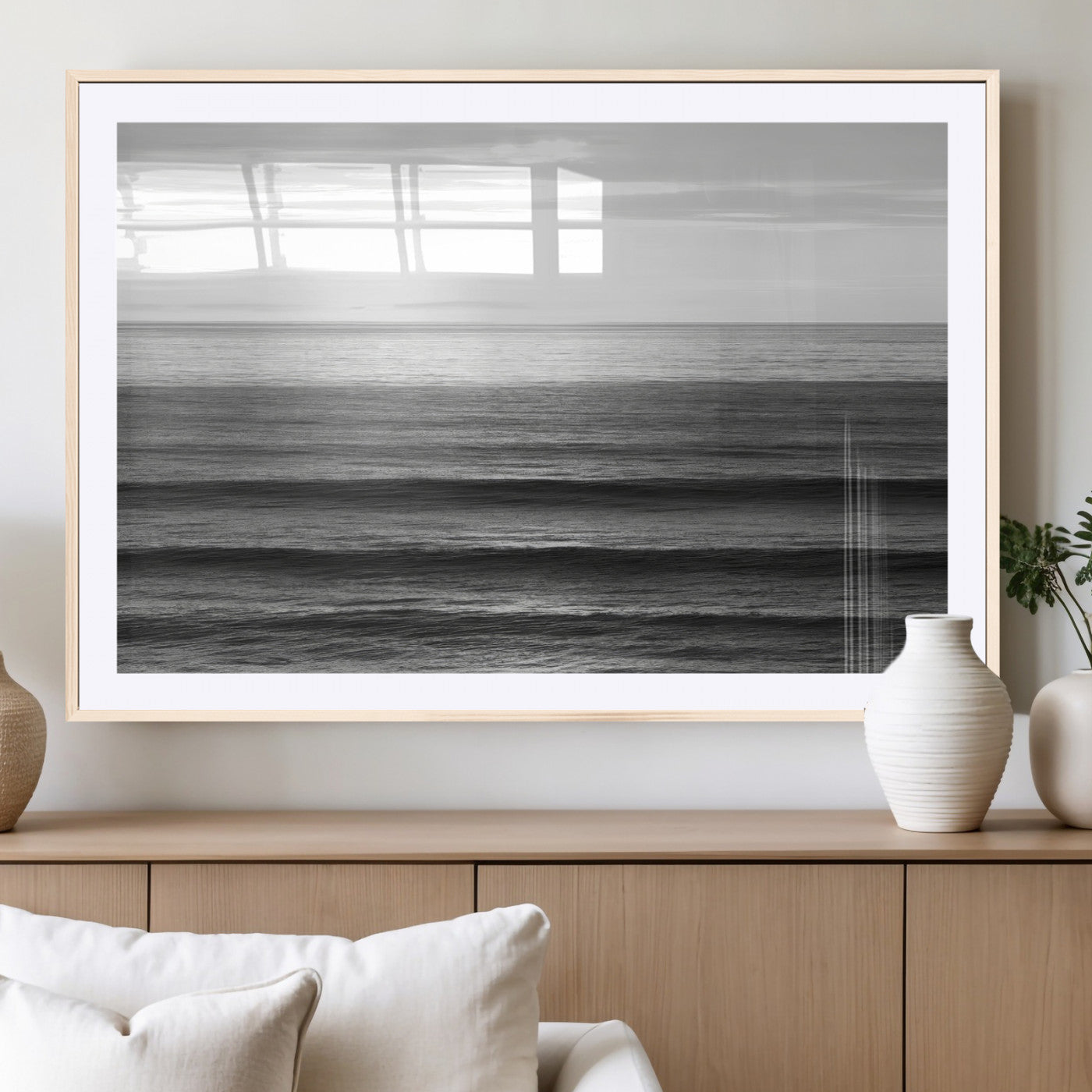 Minimalist black and white ocean view with layered waves reflecting sunlight, evoking a sense of calm and coastal serenity.
