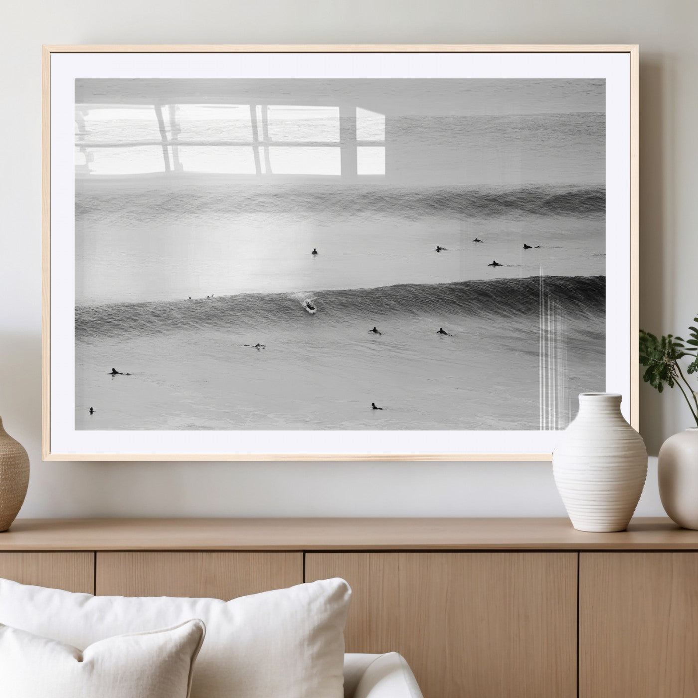 A monochrome photograph of swimmers gliding through gentle ocean waves, evoking a sense of calm and movement.