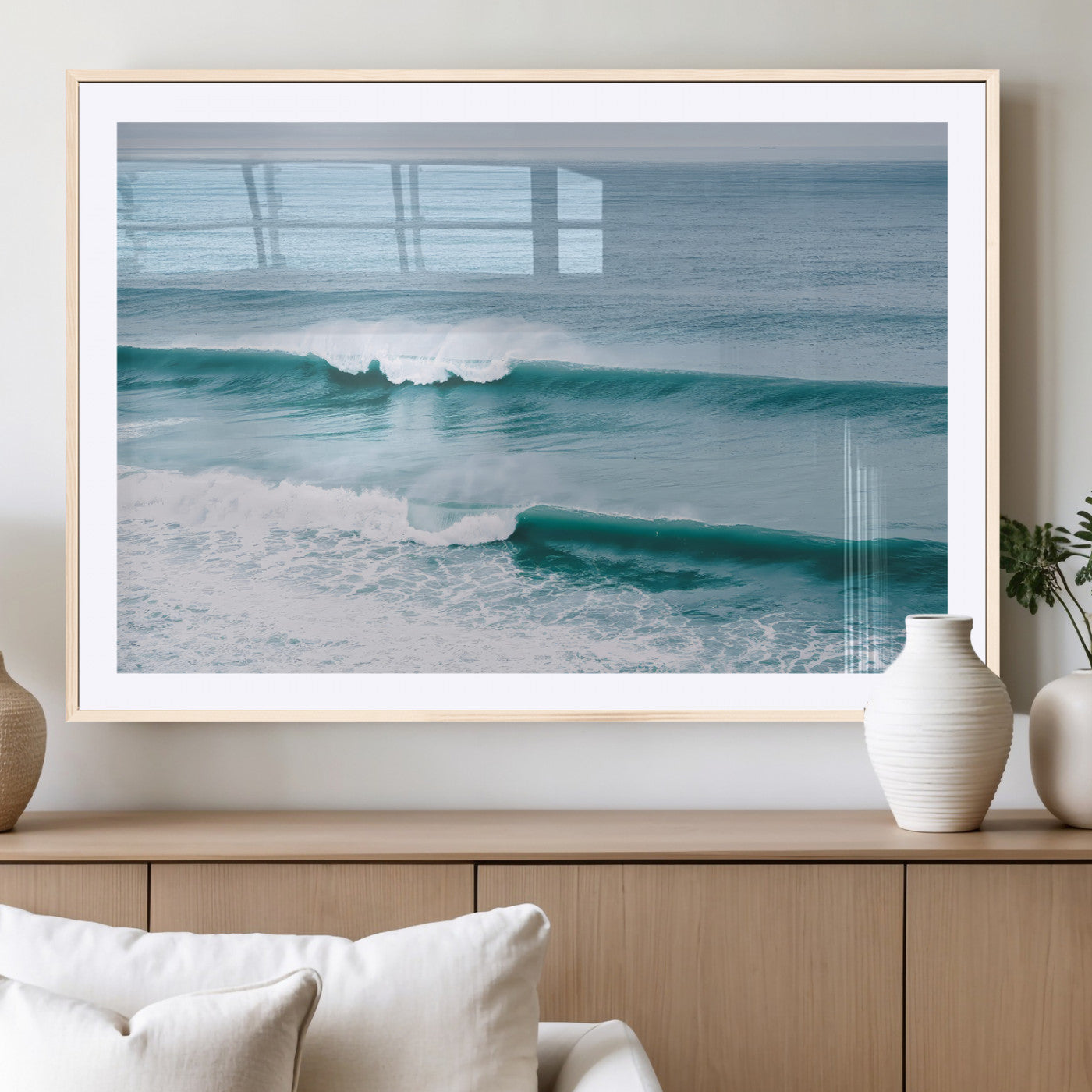 Powerful ocean waves rolling towards the shore, their turquoise hues blending with white sea foam under an open horizon, capturing the essence of the ocean's movement.