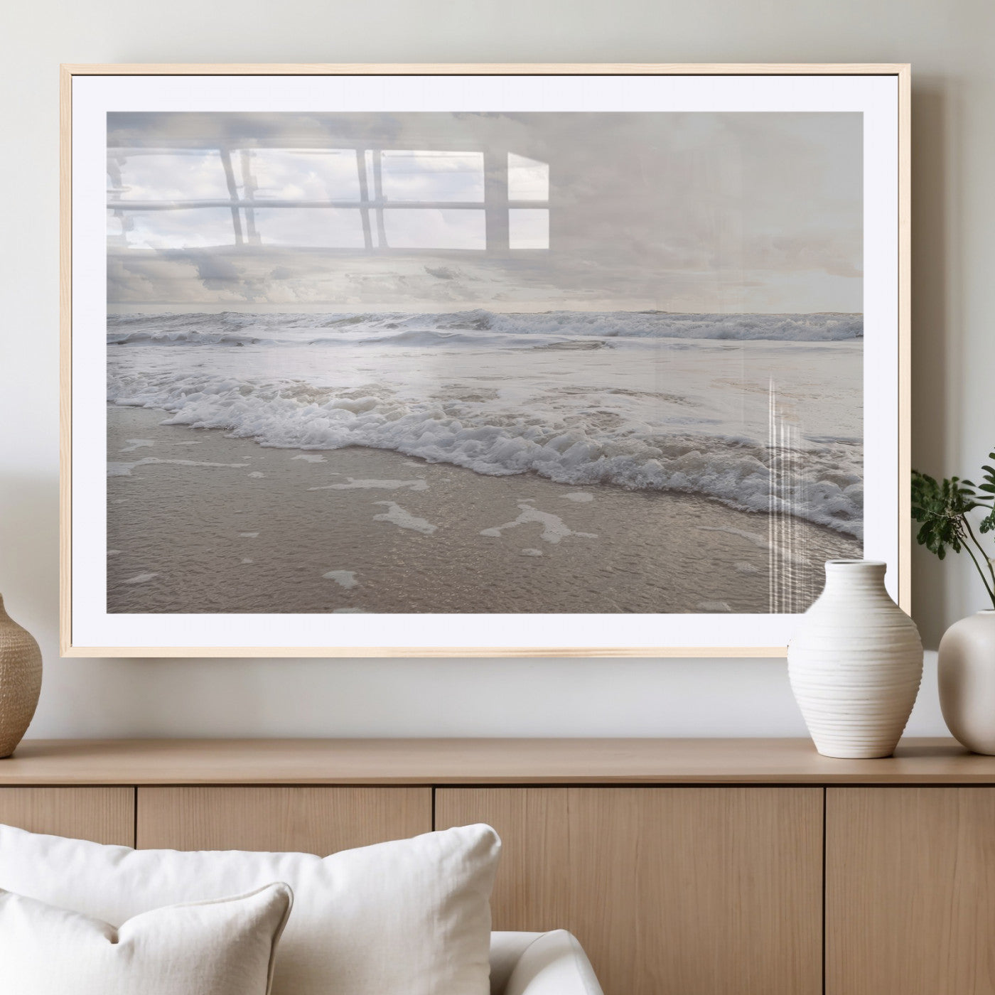 Peaceful ocean waves rolling onto the sandy shore under soft light, perfect for neutral or coastal minimalist decor themes.