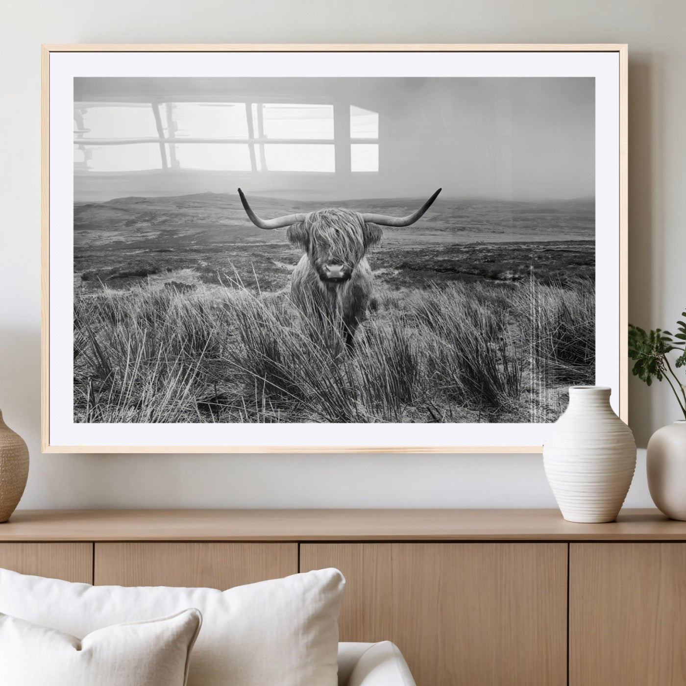A black and white portrait of a Highland cow in a foggy Scottish countryside, capturing a rustic aesthetic and tranquil farm escape.